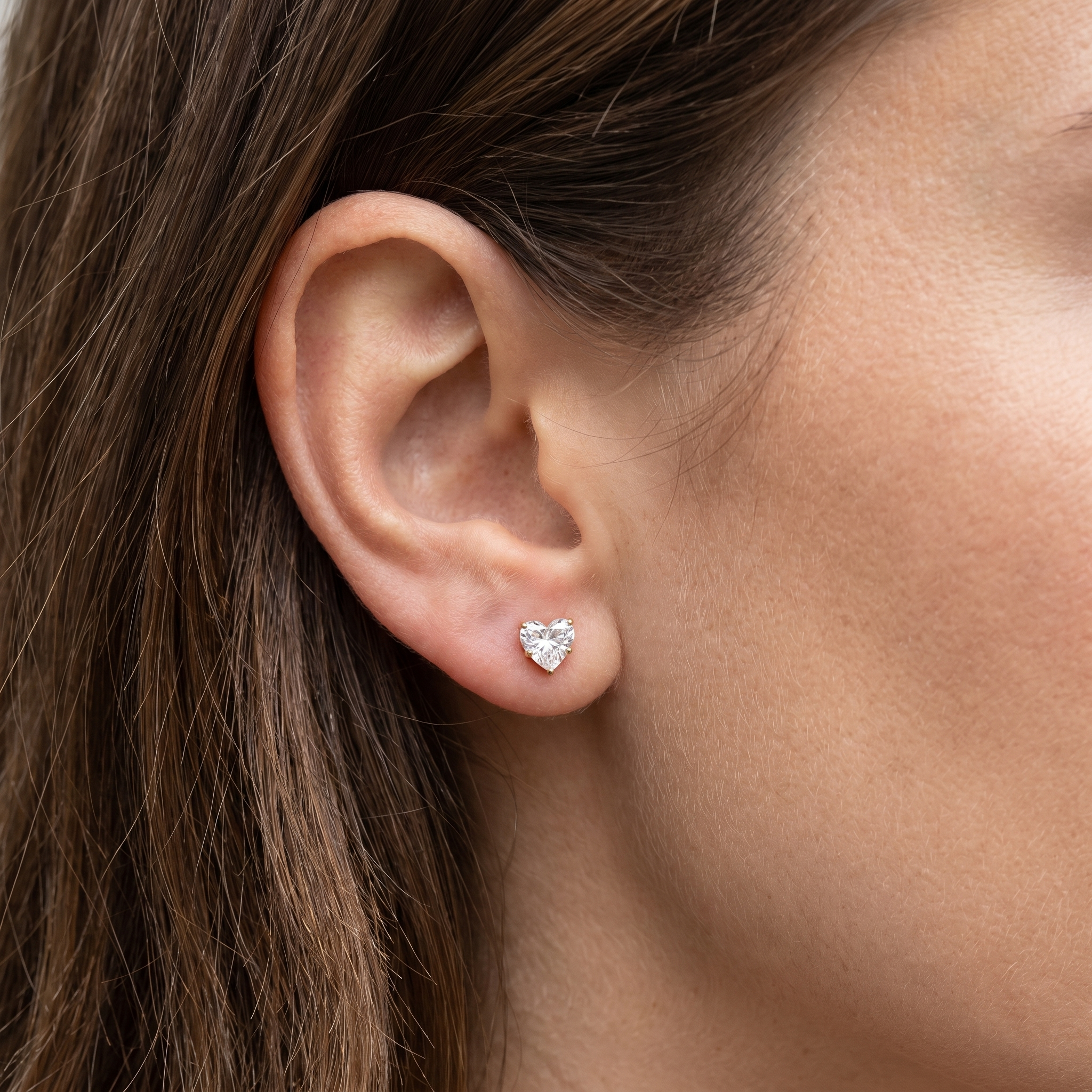 Gold romantic cartilage jewelry styled beautifully in a high placement.