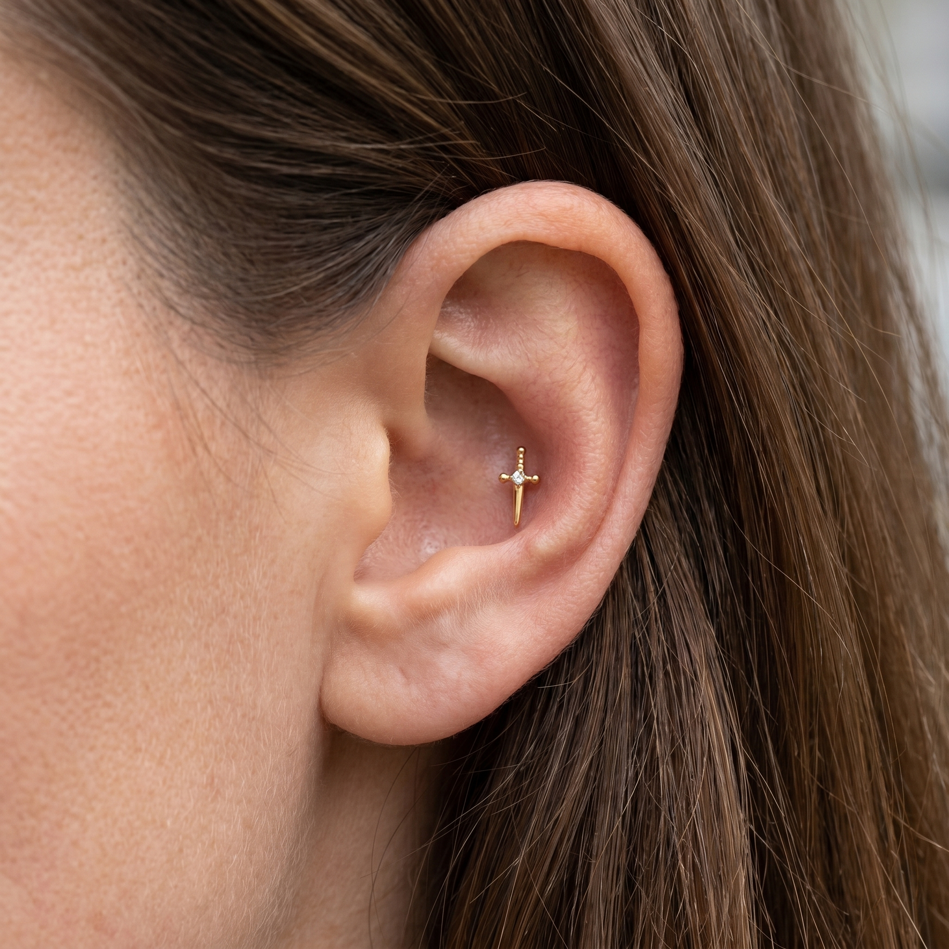 Gold dagger zircon stud — conch jewelry placement