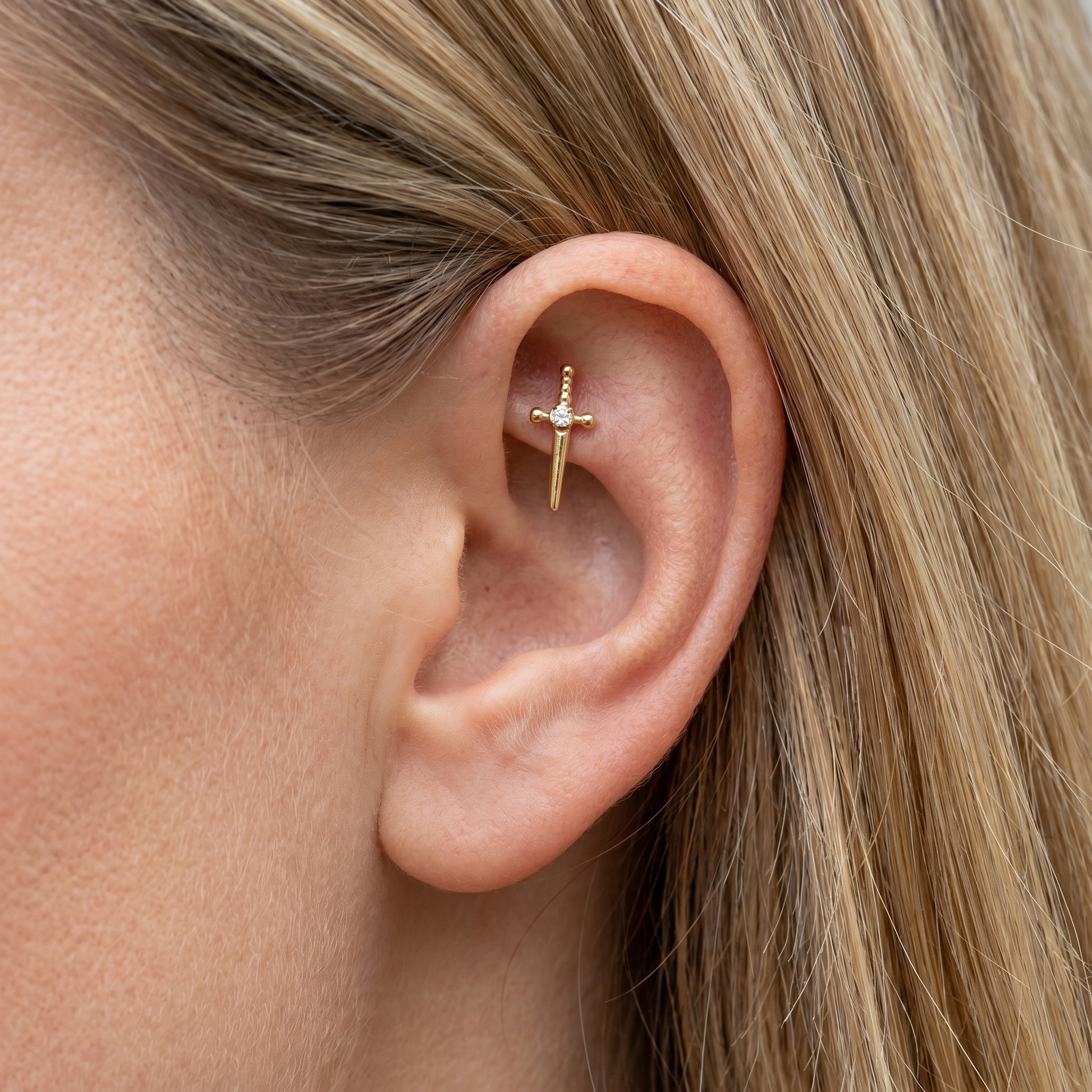 Gold dagger zircon stud — faux rook piercing placement