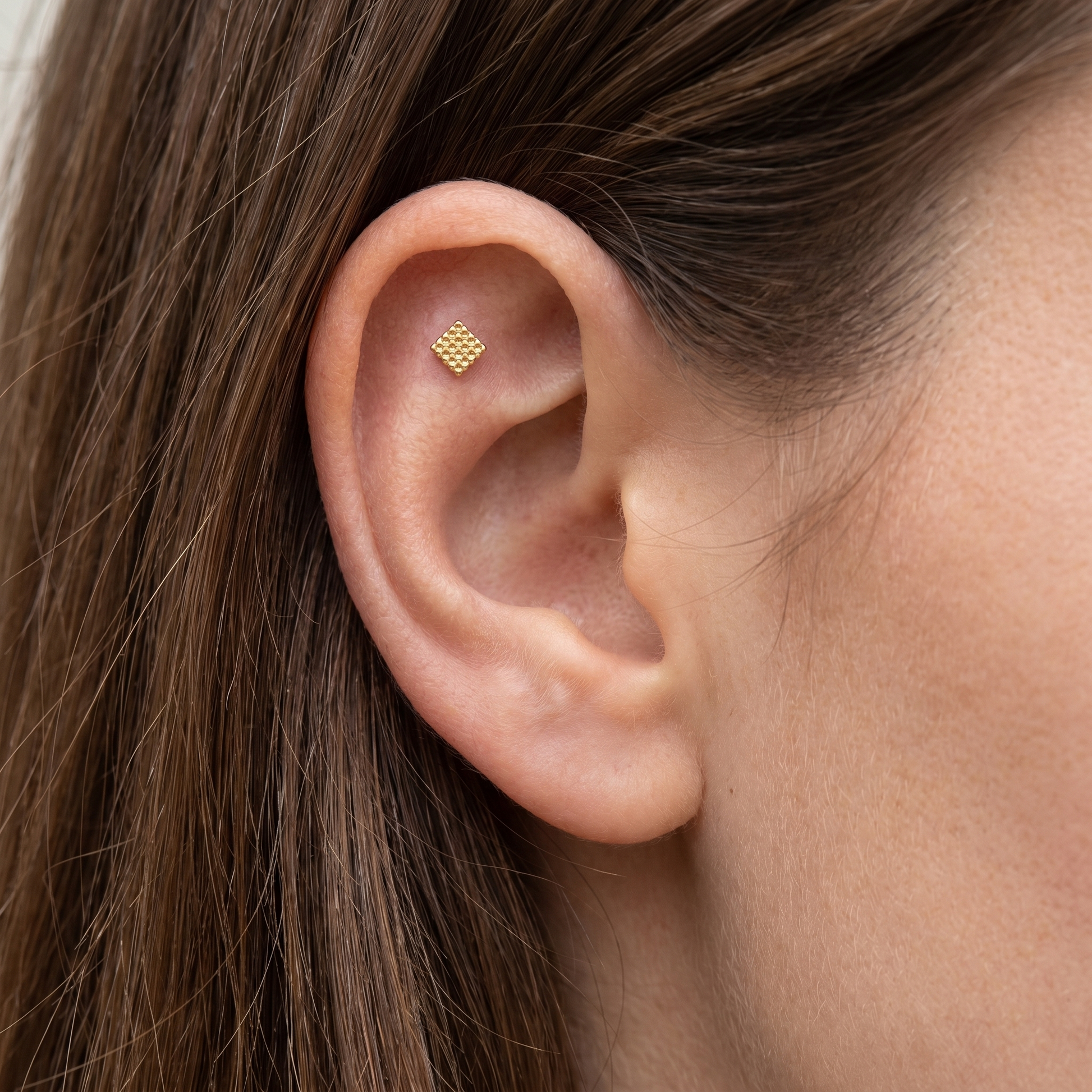 Gold geometric square grid stud — flat helix piercing placement