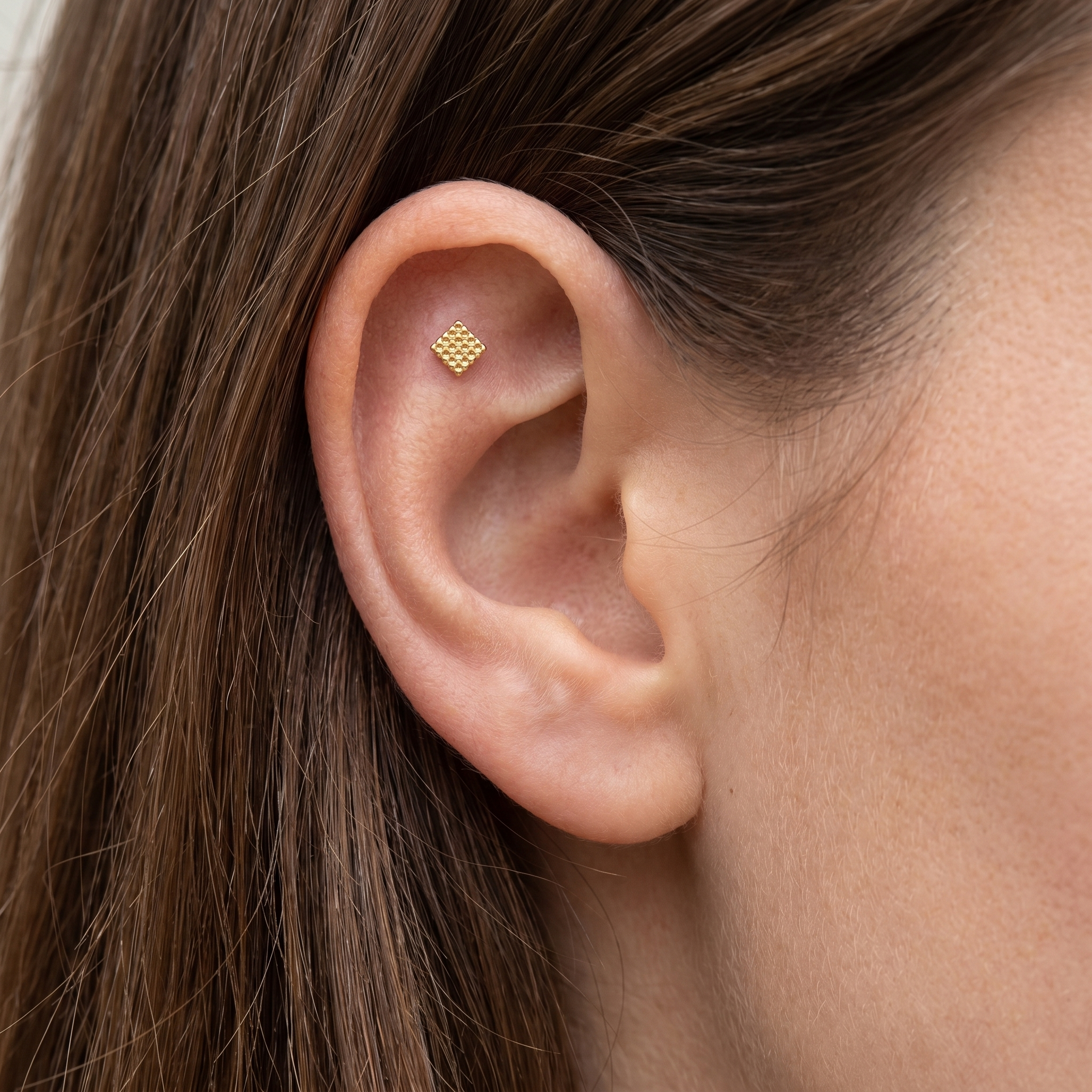 Gold geometric square grid stud — flat helix piercing placement