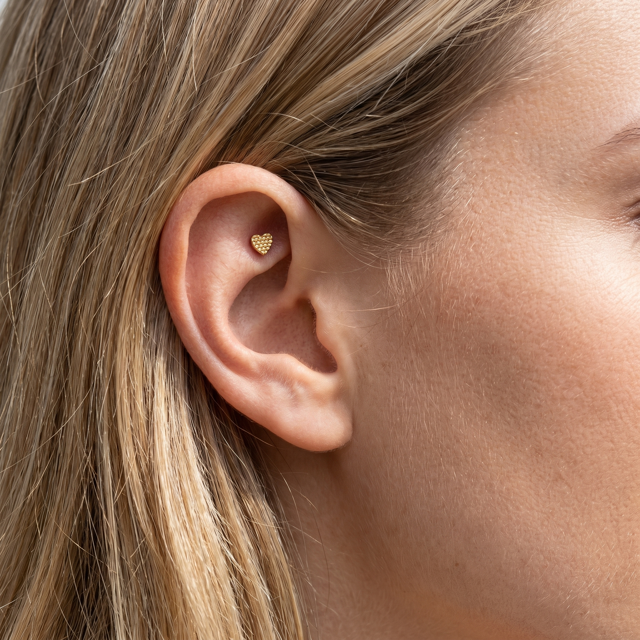 Gold textured heart stud — faux rook piercing placement