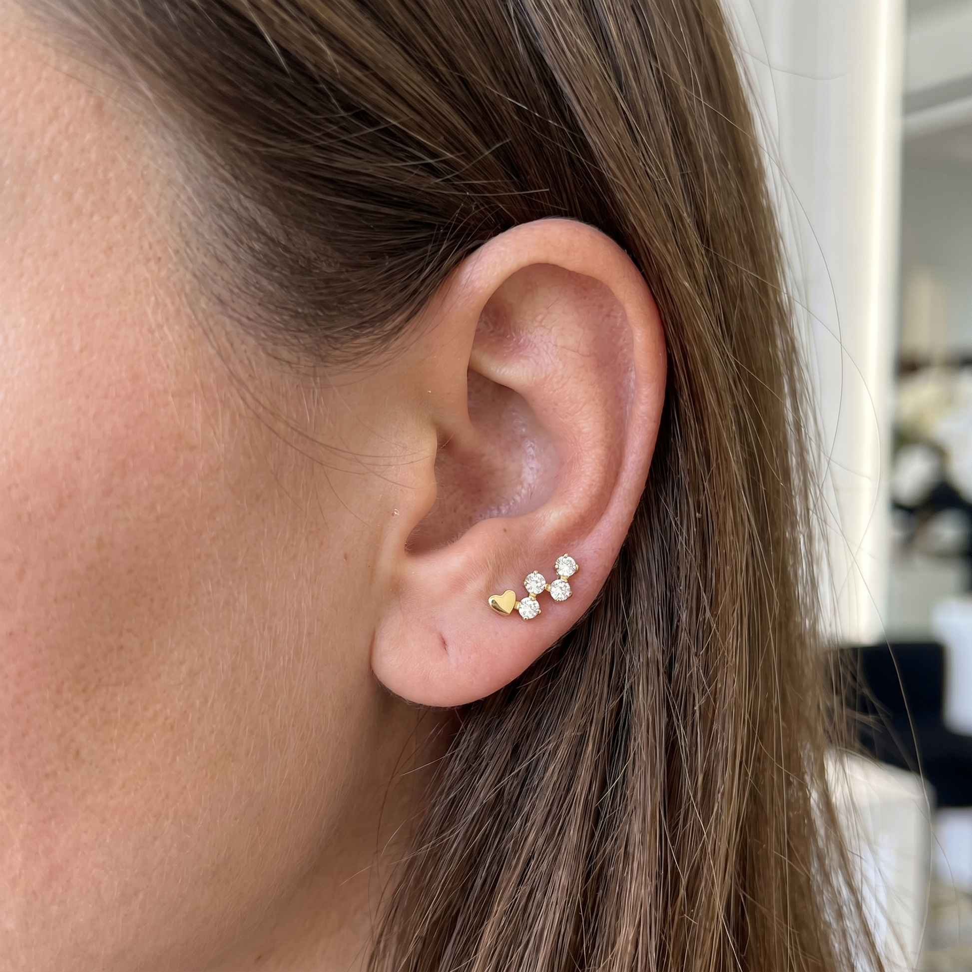 Gold heart & zircon stud — anti tragus placement
