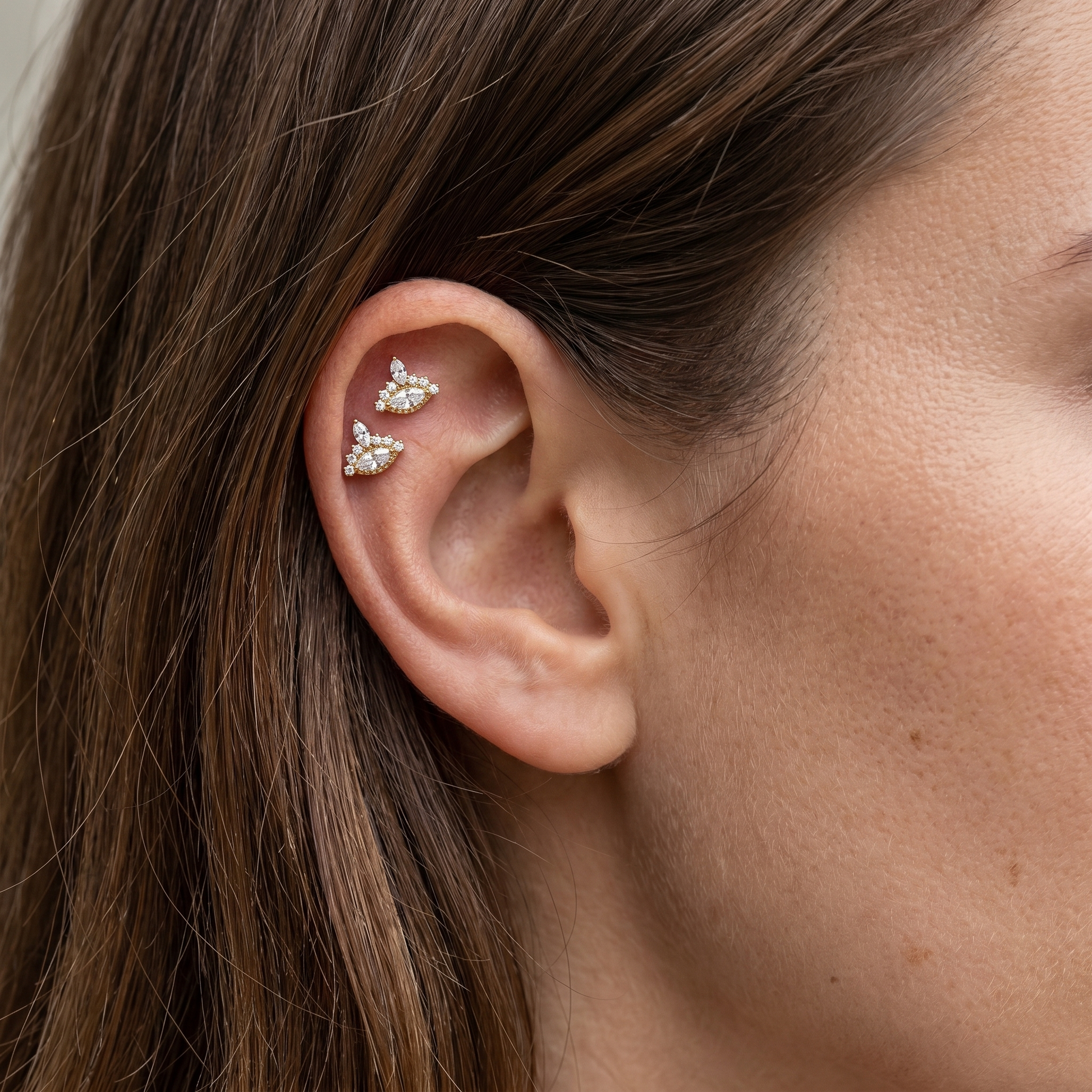 Gold evil eye stud — double helix piercing placement