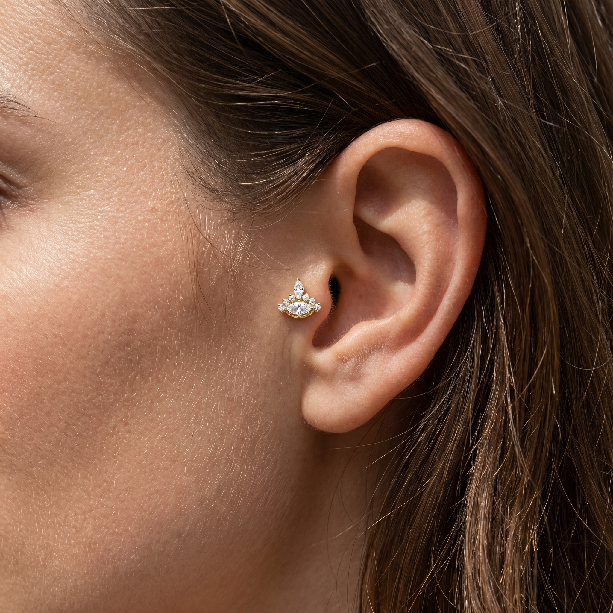 Gold evil eye stud — tragus jewelry placement