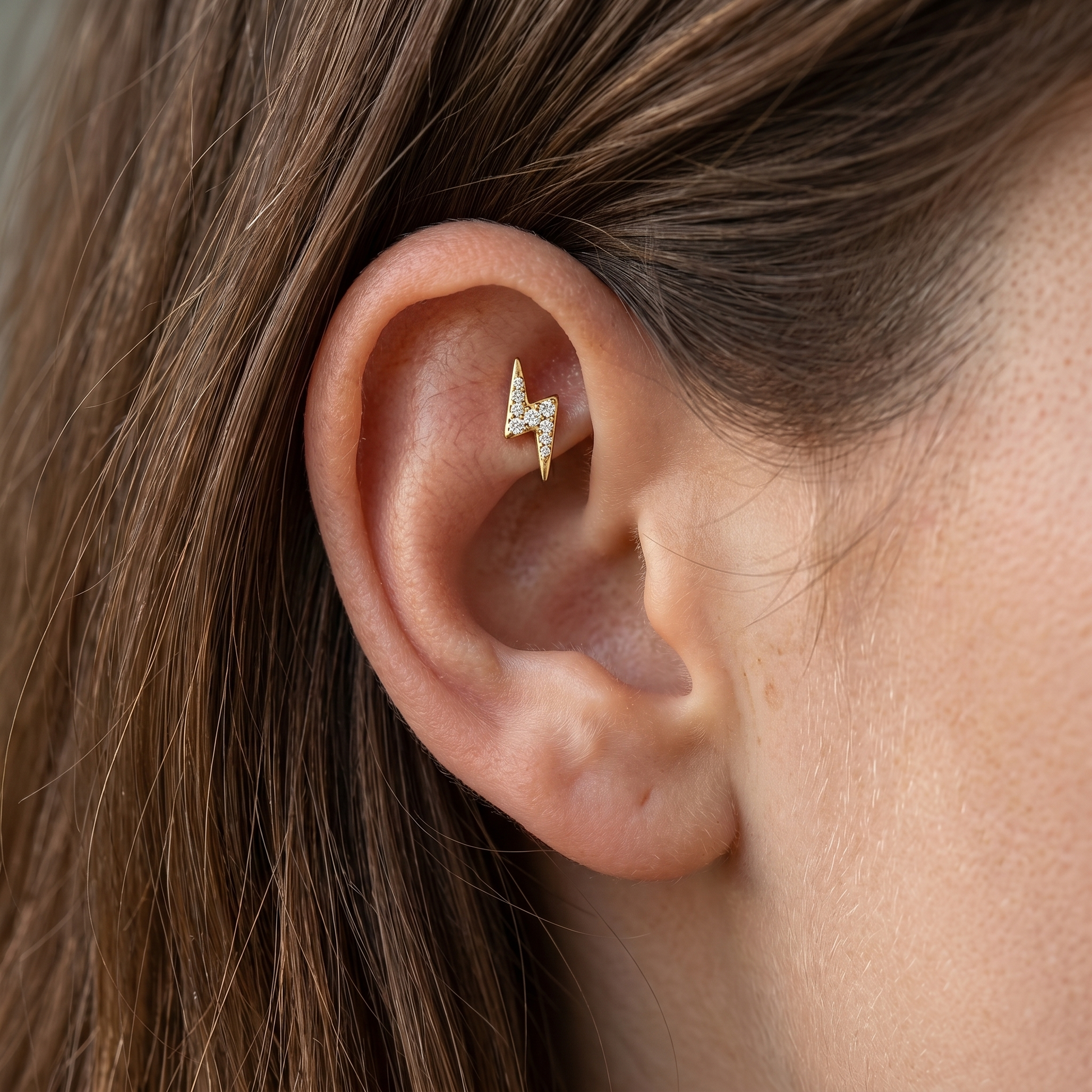 Gold lightning bolt faux piercing jewelry in a 16G.