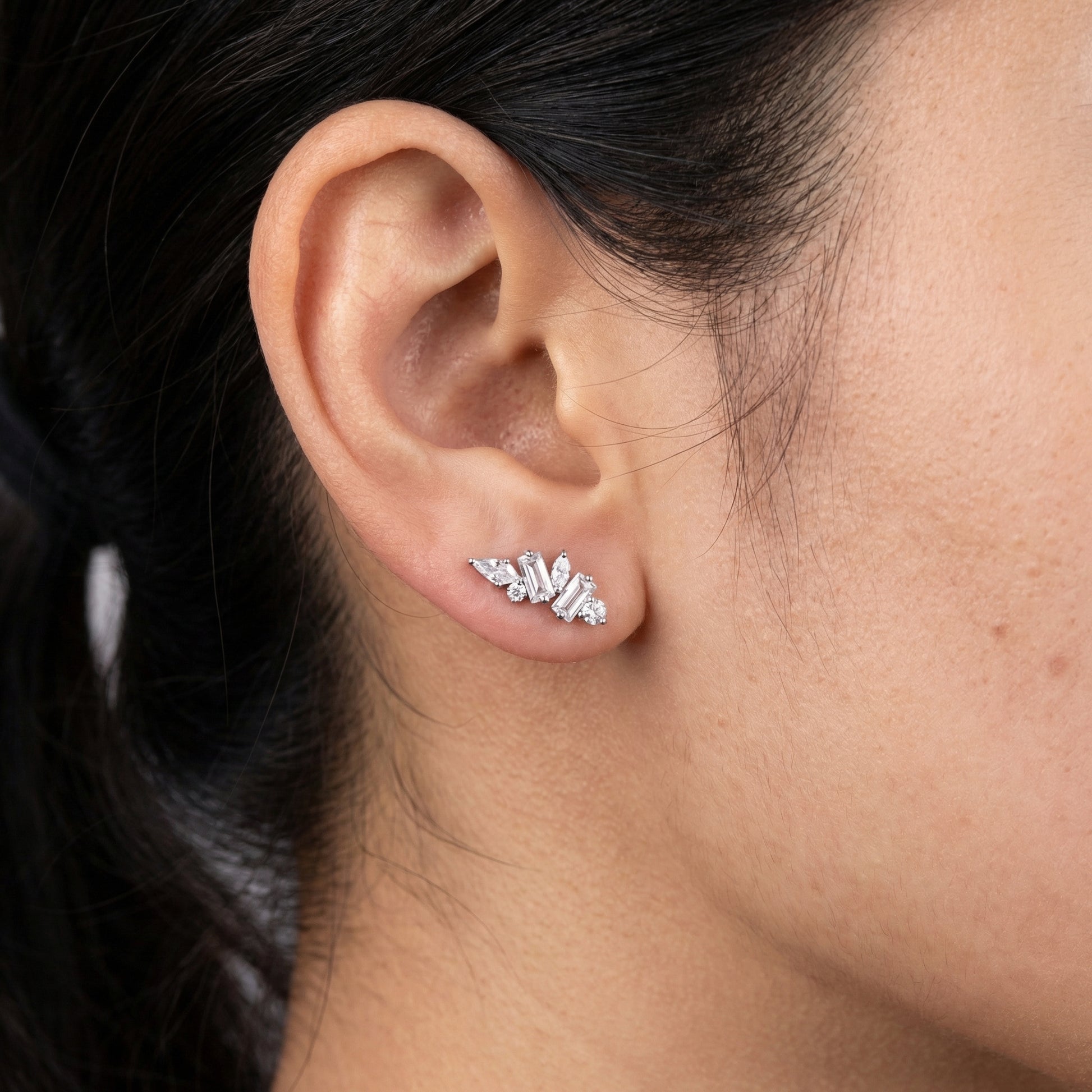Model profile displaying a silver multi-stone zircon cluster in her standard lower