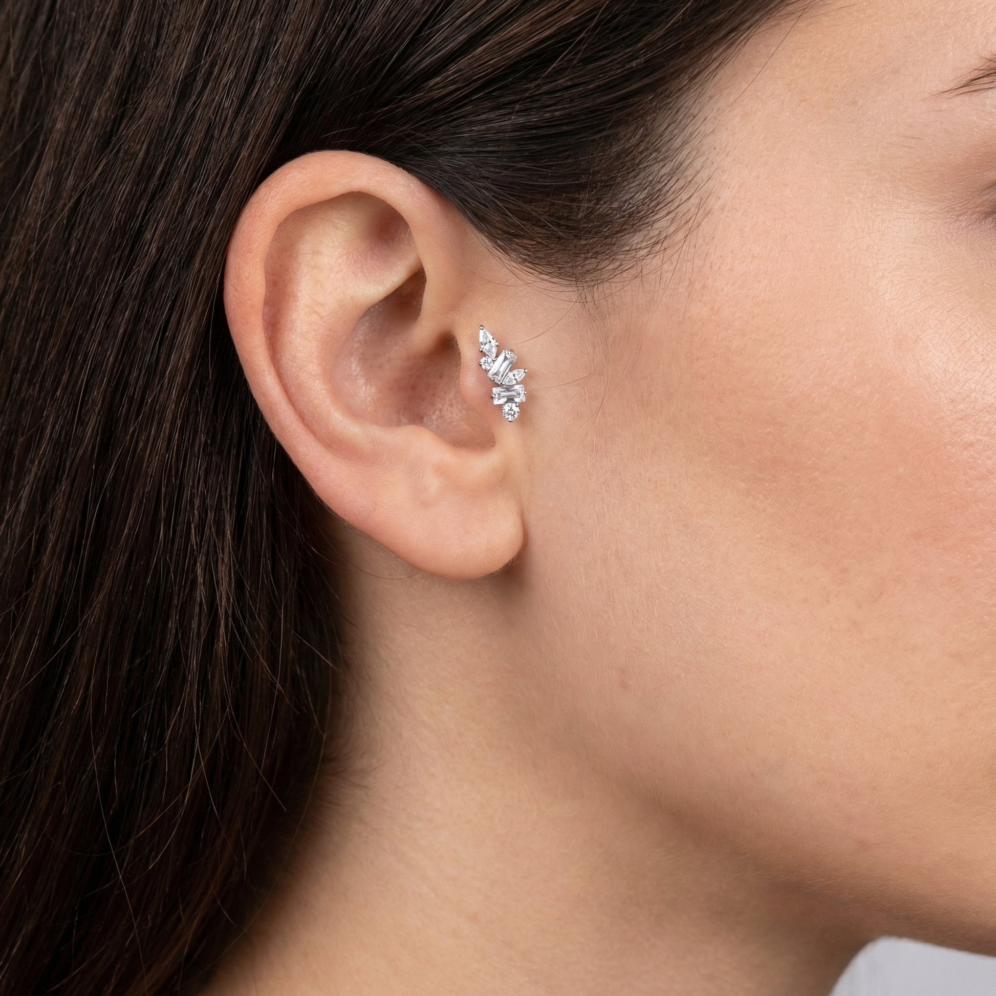 Close-up of a silver multi-stone zircon cluster styled seamlessly inside a model's
