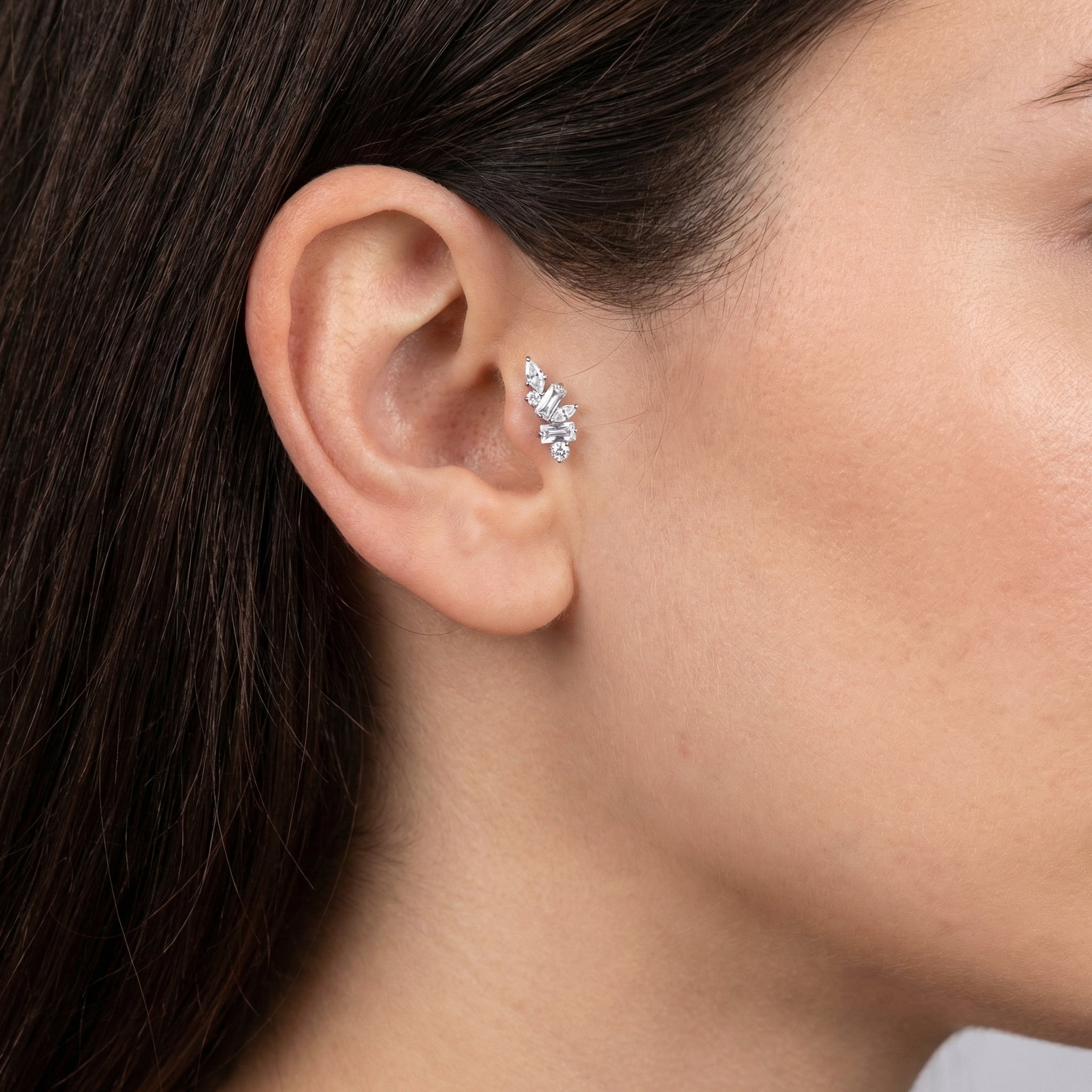 Close-up of a silver multi-stone zircon cluster styled seamlessly inside a model's