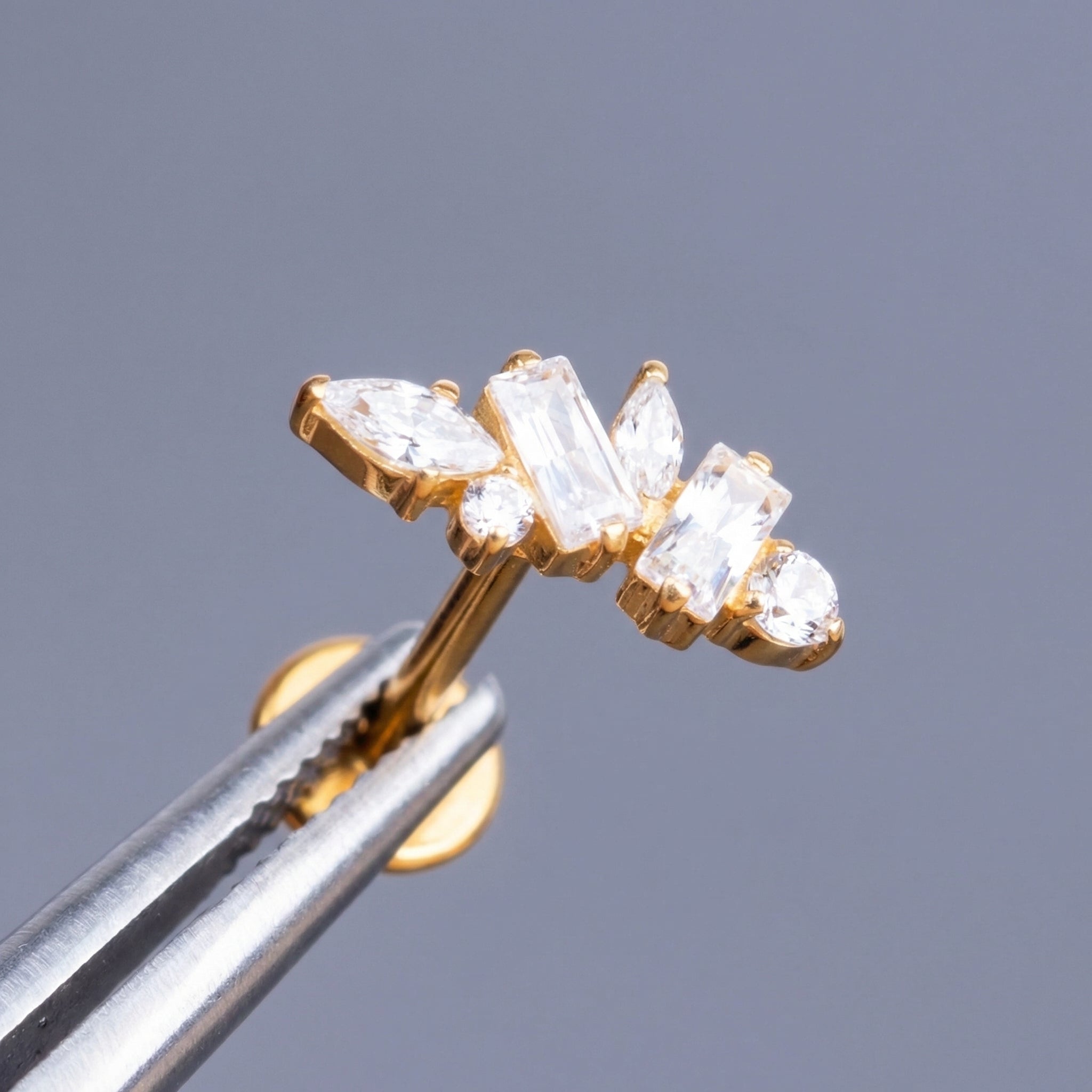 Multi Front Helix Piercing - Precision tweezers holding a