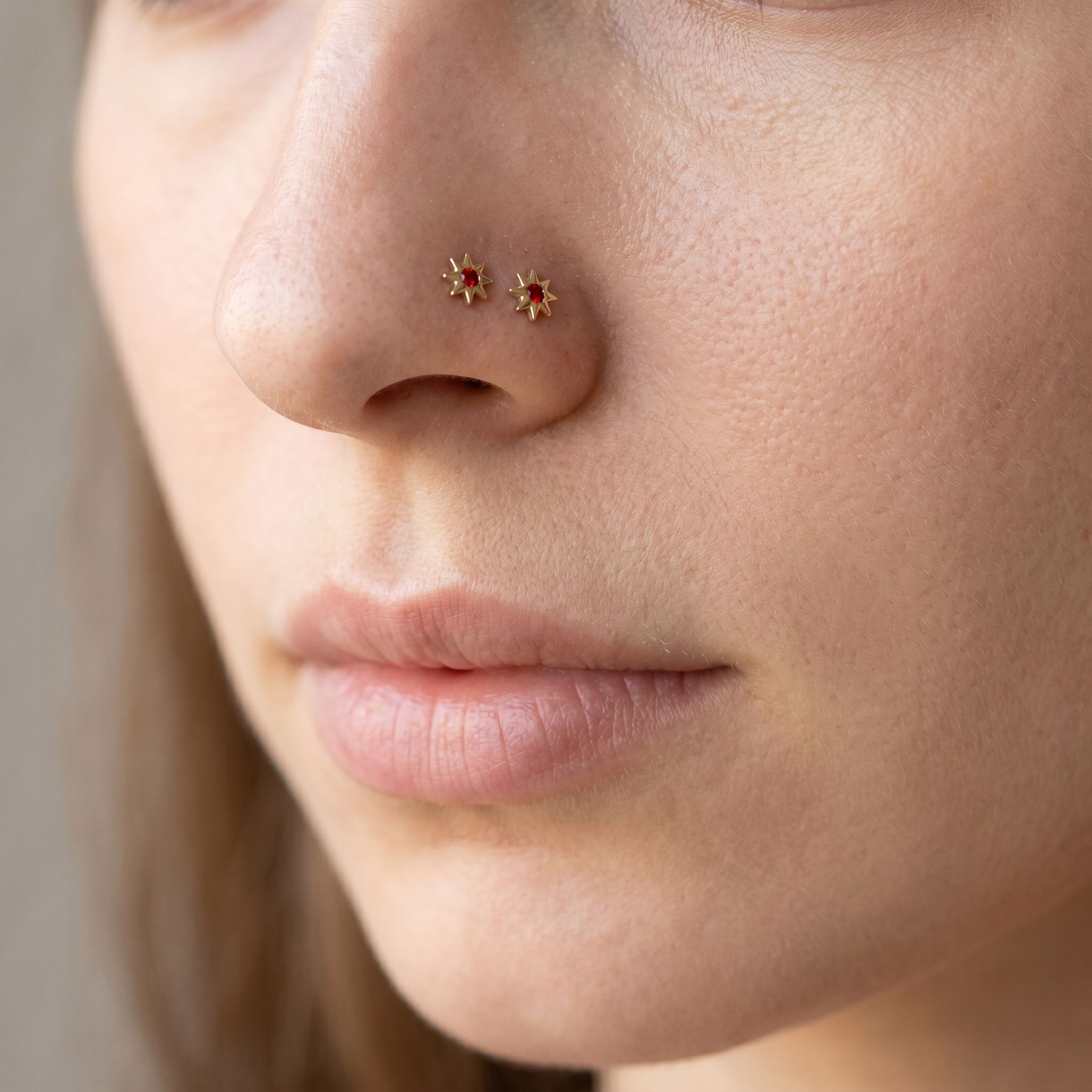 north star nose stud styled on a model, 20G titanium