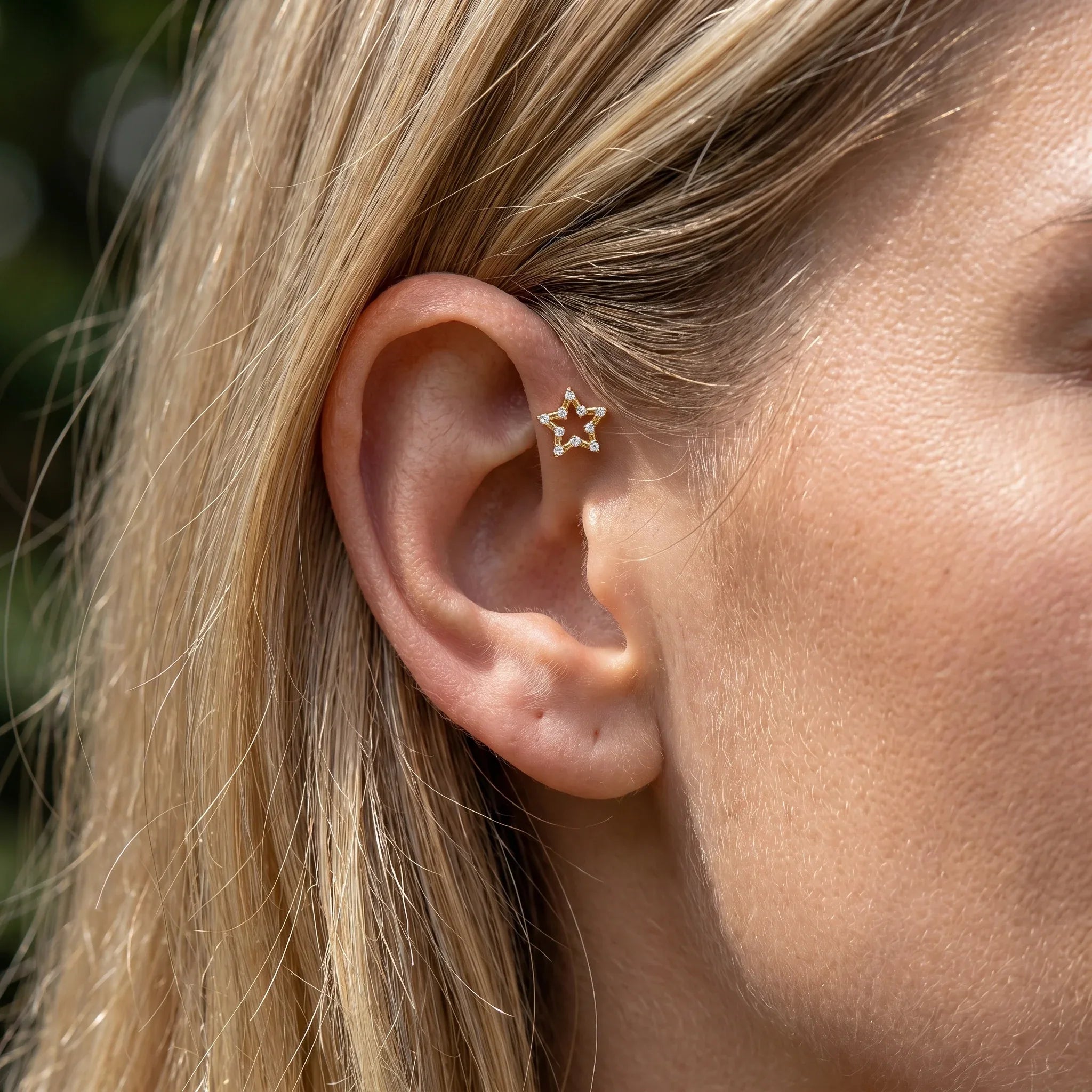 Gold open star piercing stud worn gracefully in a .