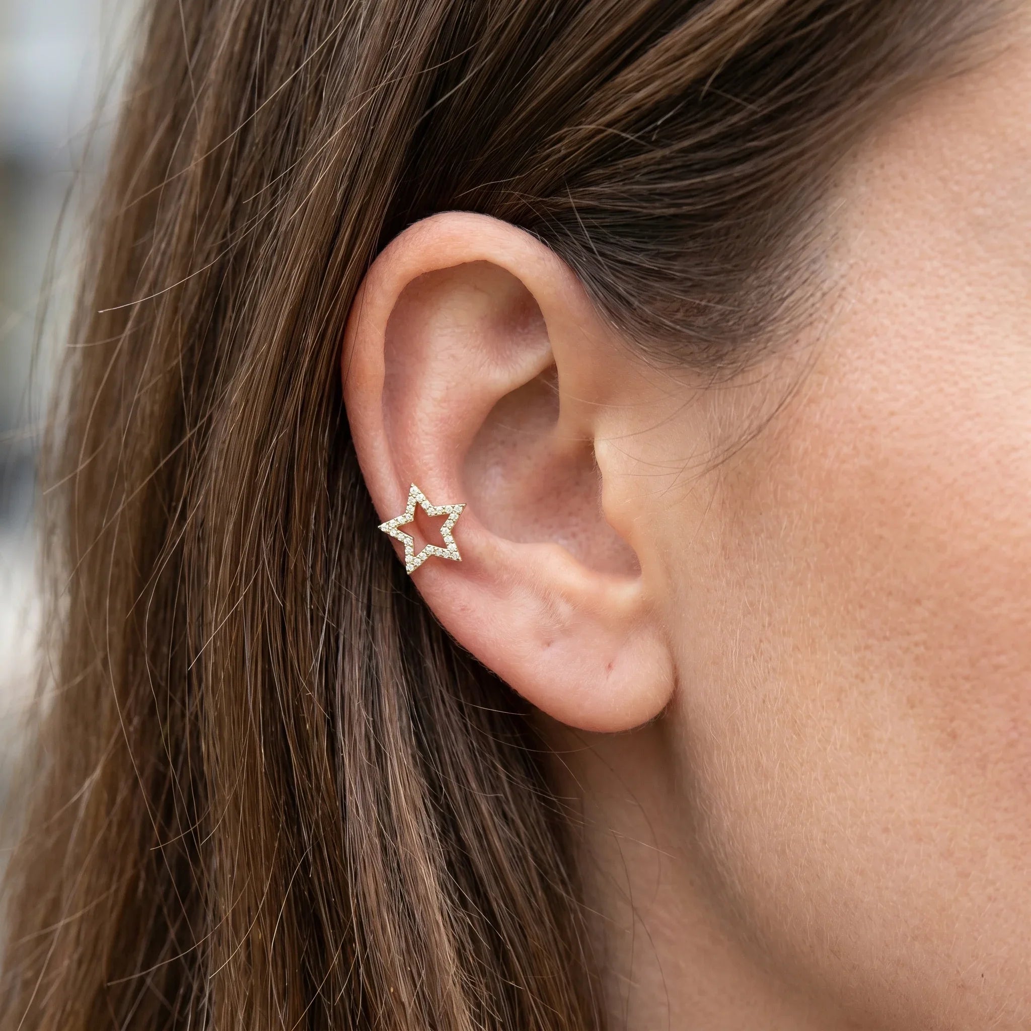 Gold medical-grade titanium piercing worn perfectly in a piercing.