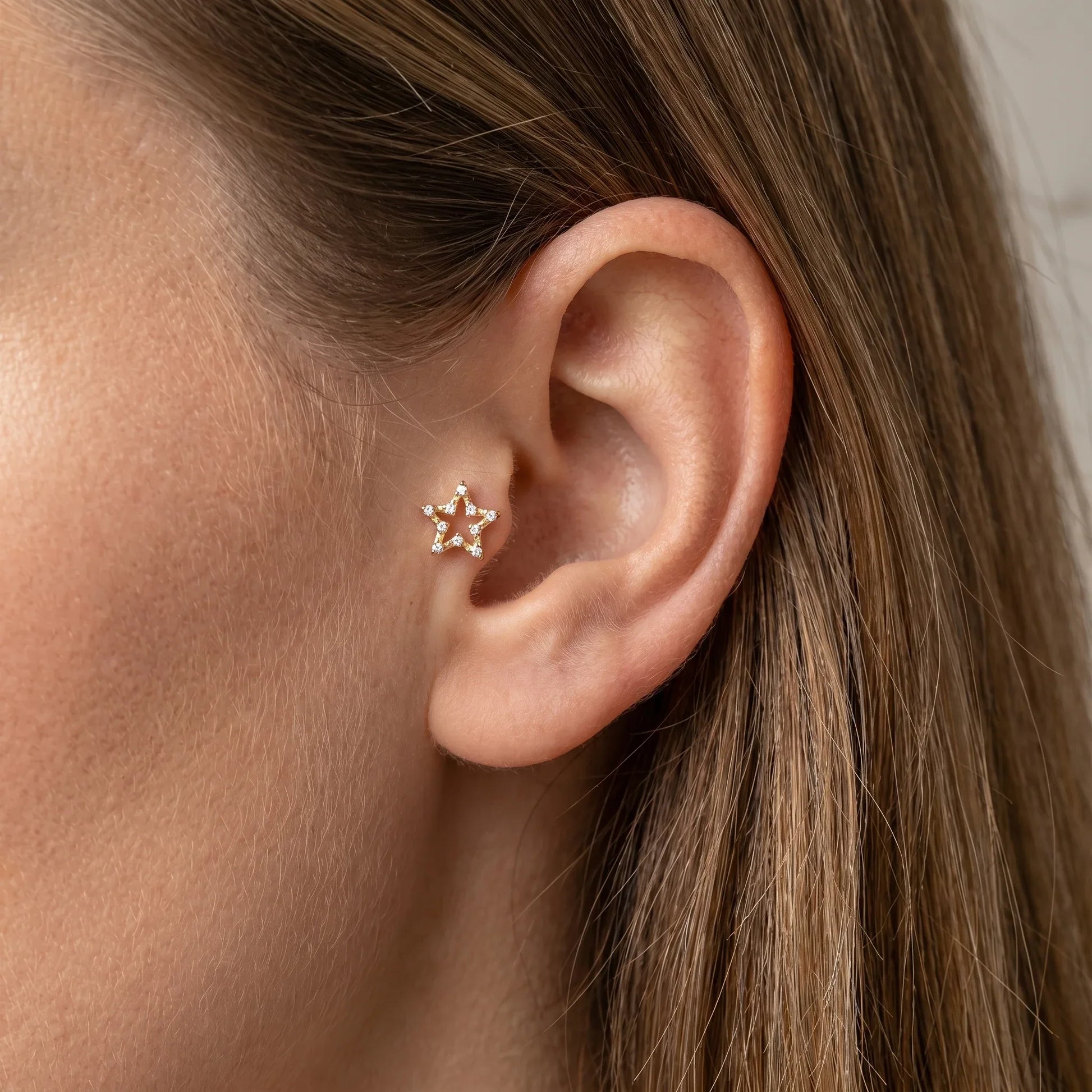 Gold celestial cartilage stud worn elegantly in a placement.