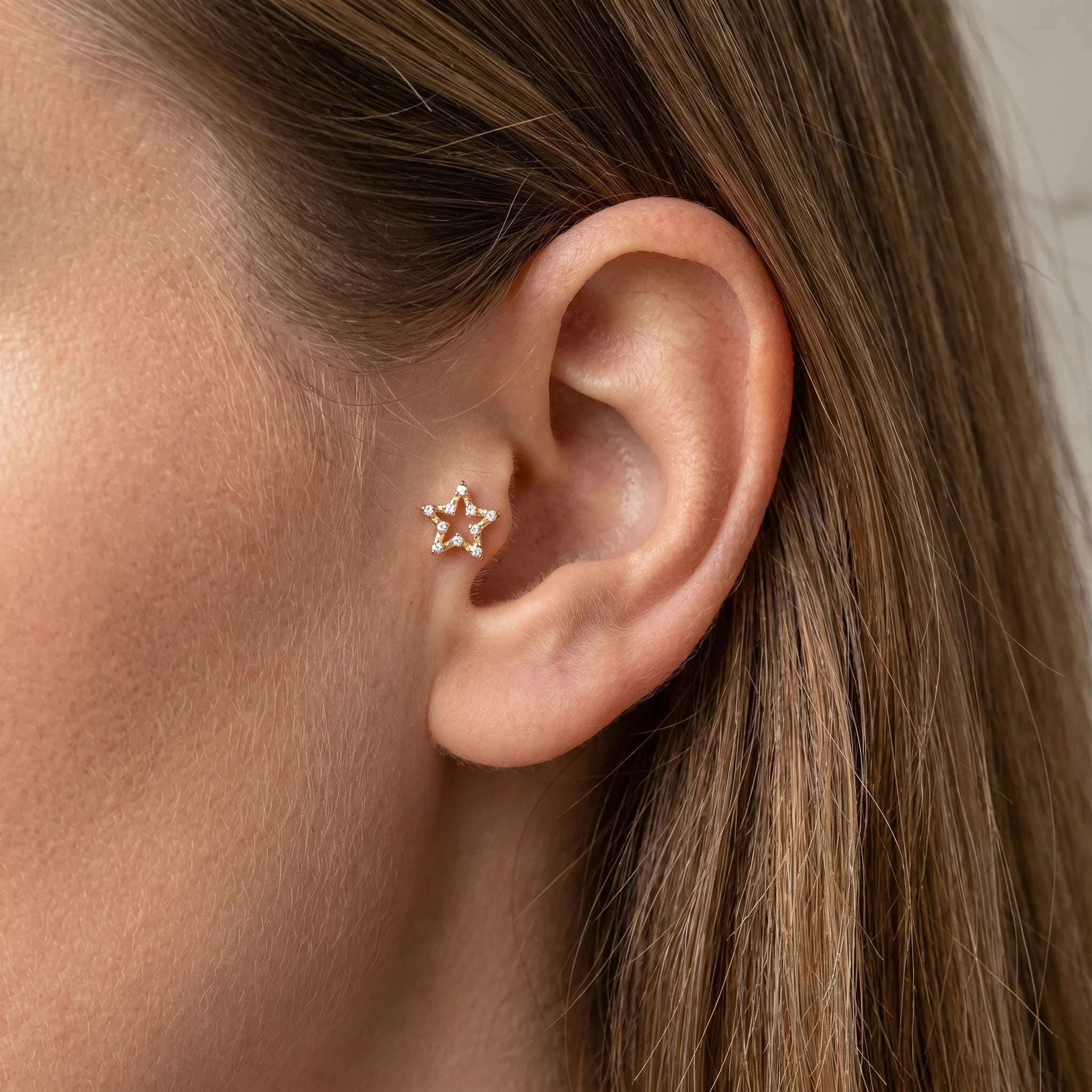 Gold celestial cartilage stud worn elegantly in a placement.
