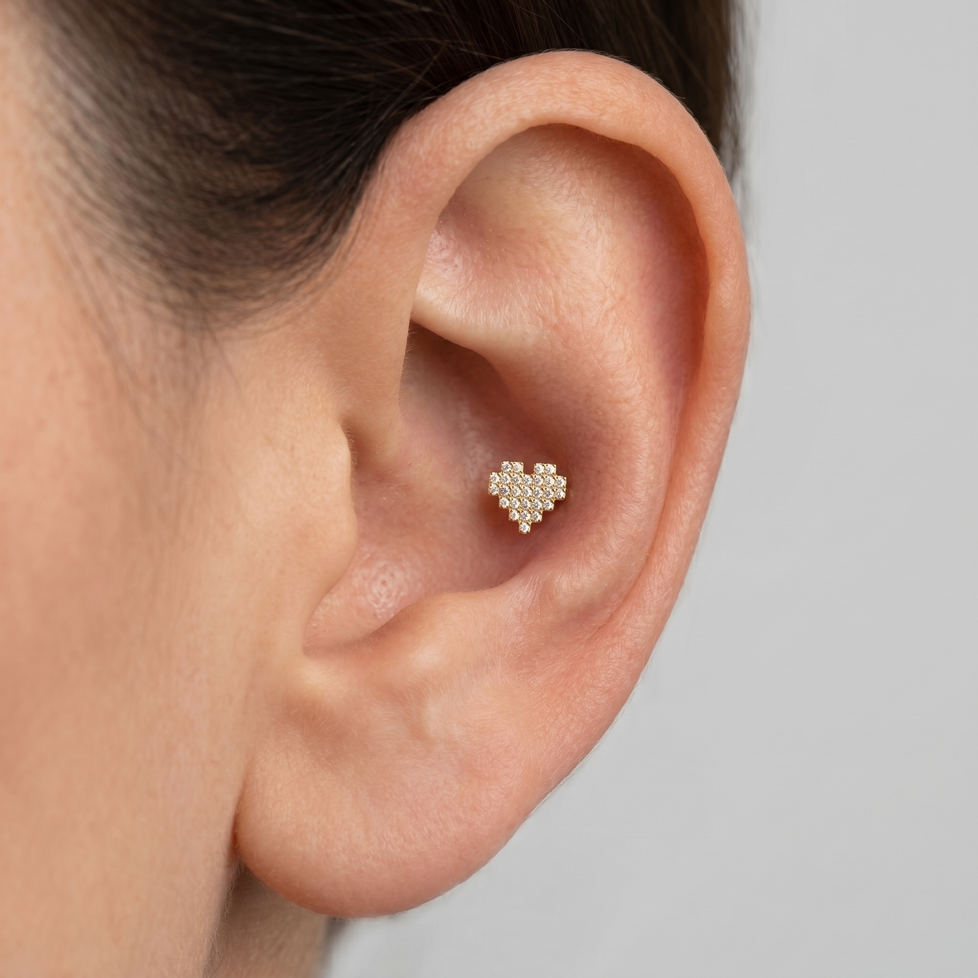 Gold paved heart stud worn beautifully in a deep ear piercing.