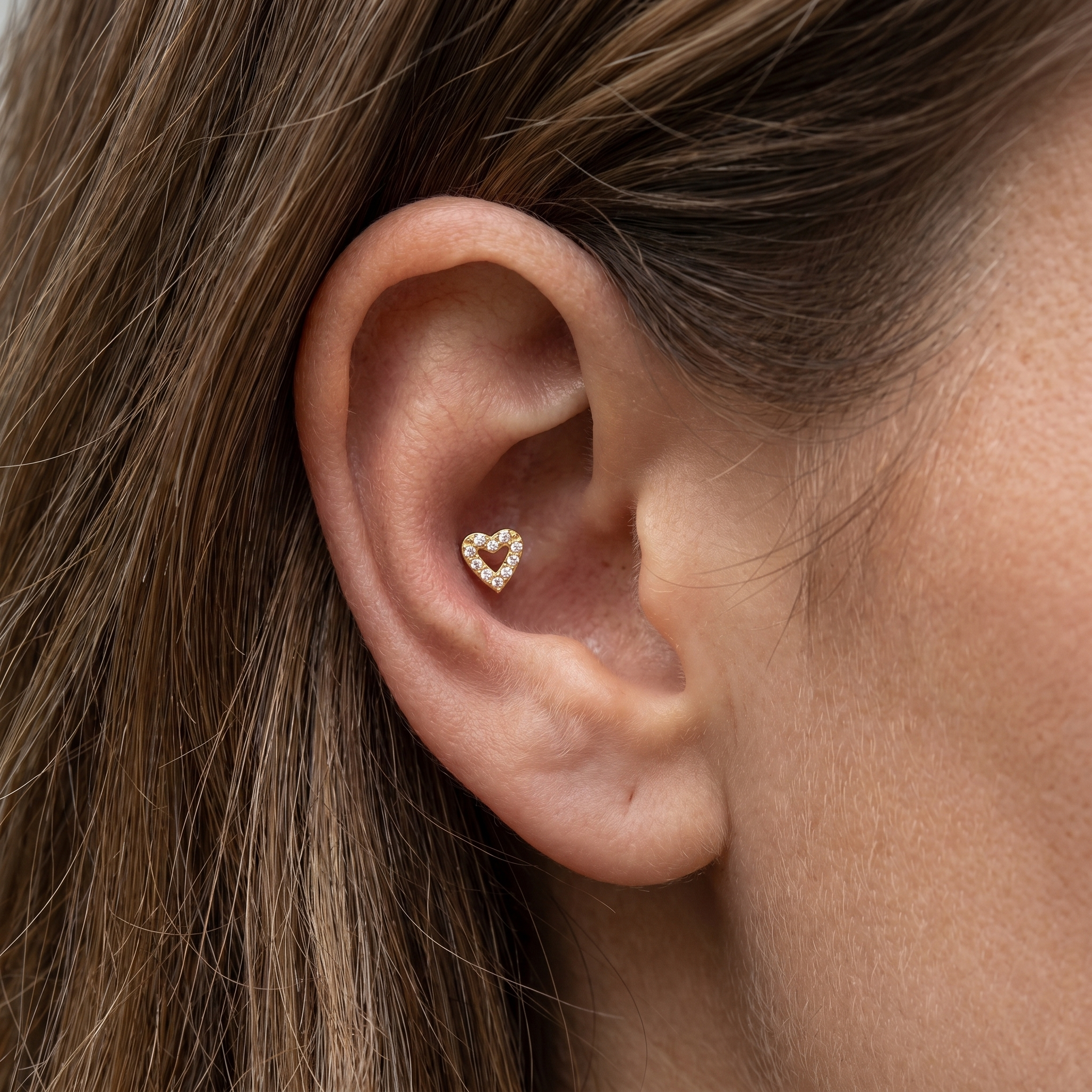 Gold medical-grade titanium stud styled in a deep piercing.