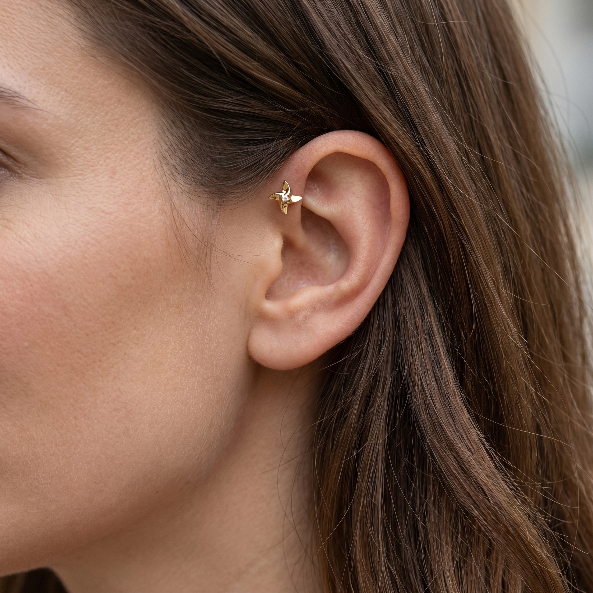 Gold titanium styled in a piercing.