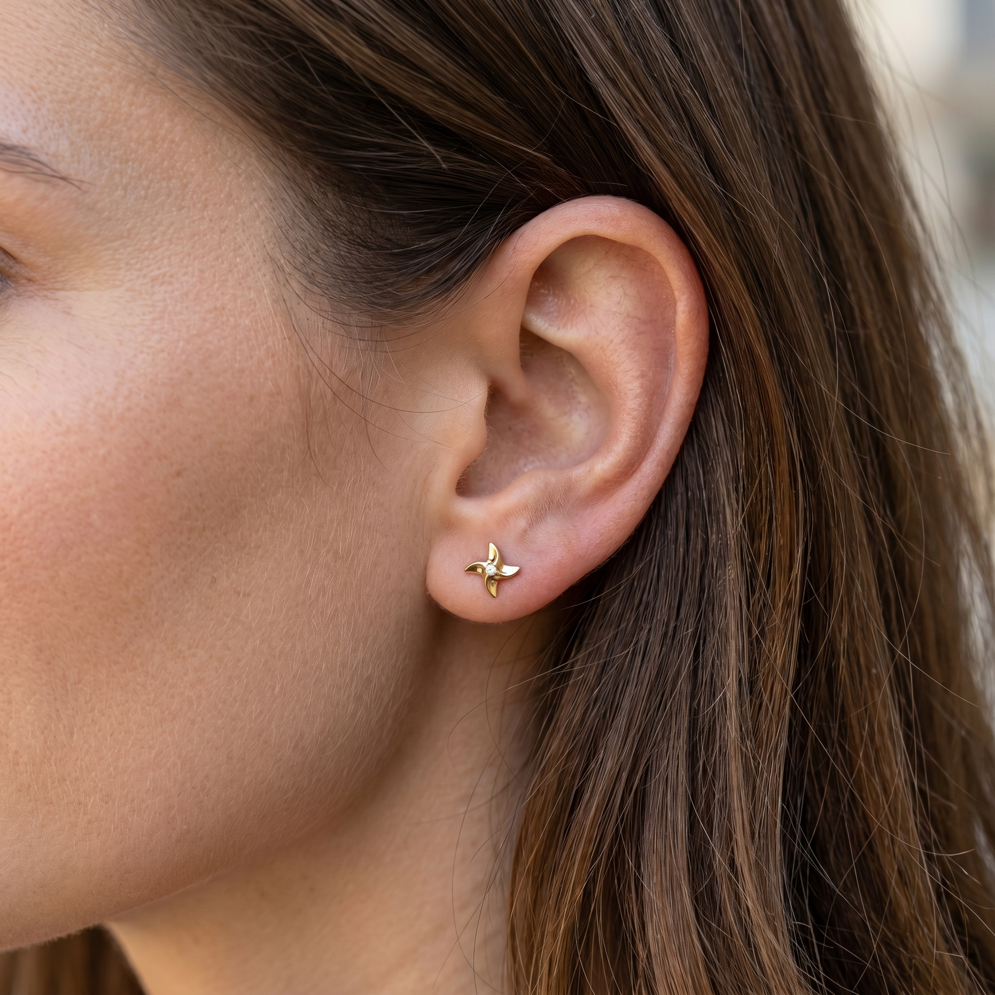 Gold playful ear stack jewelry styled in a standard piercing.