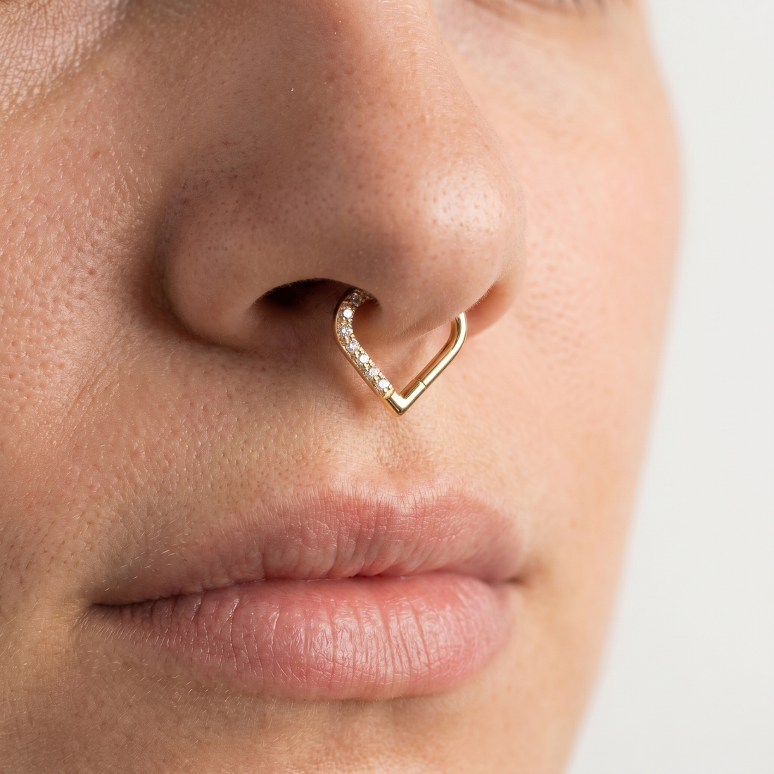 Gold romantic heart zircon stud — septum nose placement