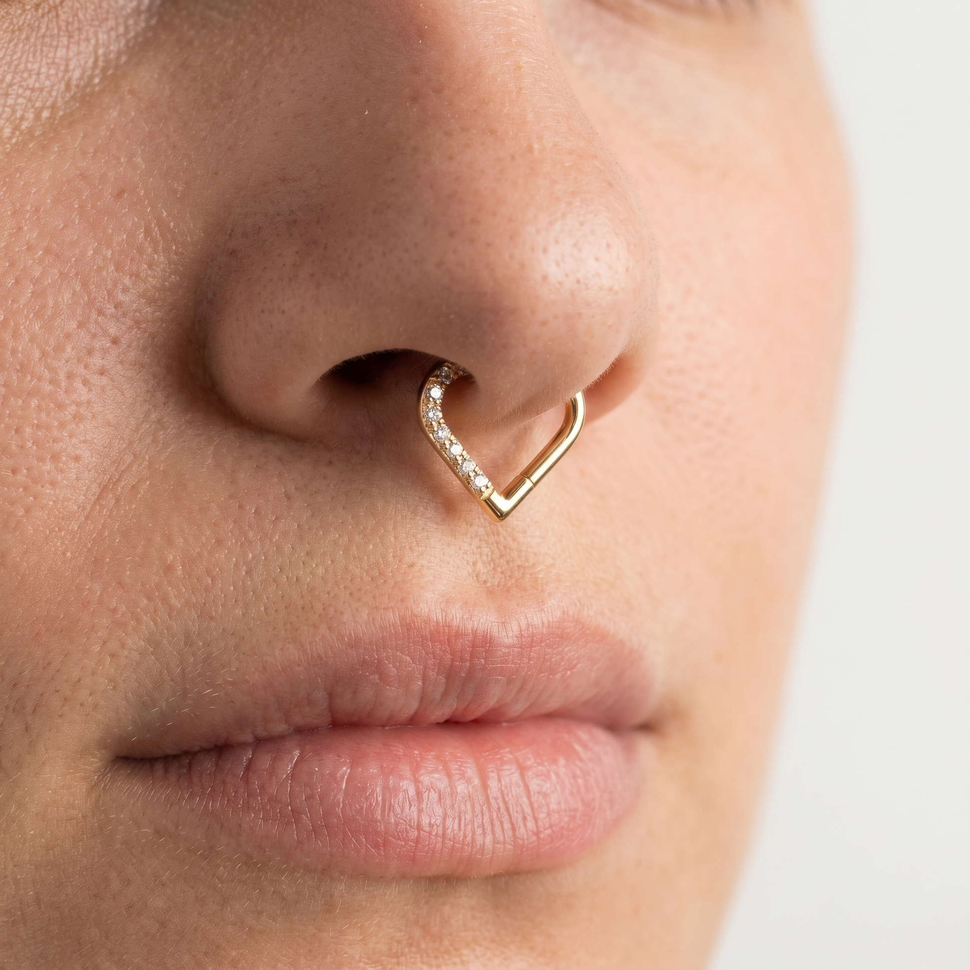 Gold romantic heart zircon stud — septum nose placement
