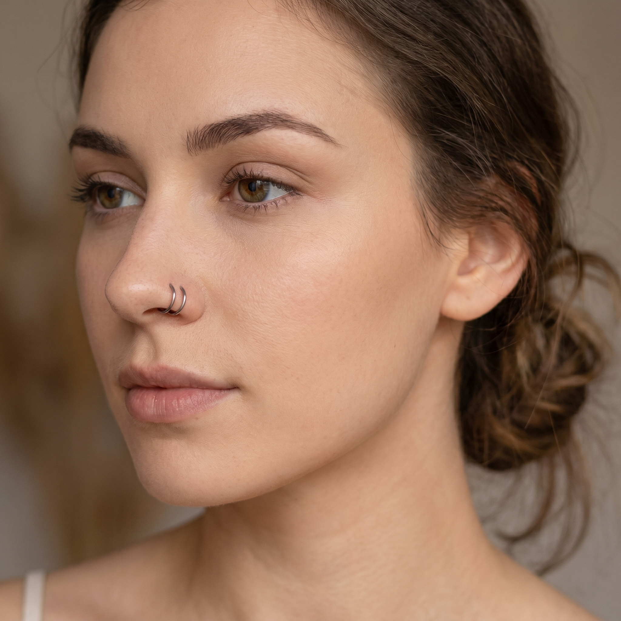 seamless nose hoop worn on a model — hypoallergenic titanium