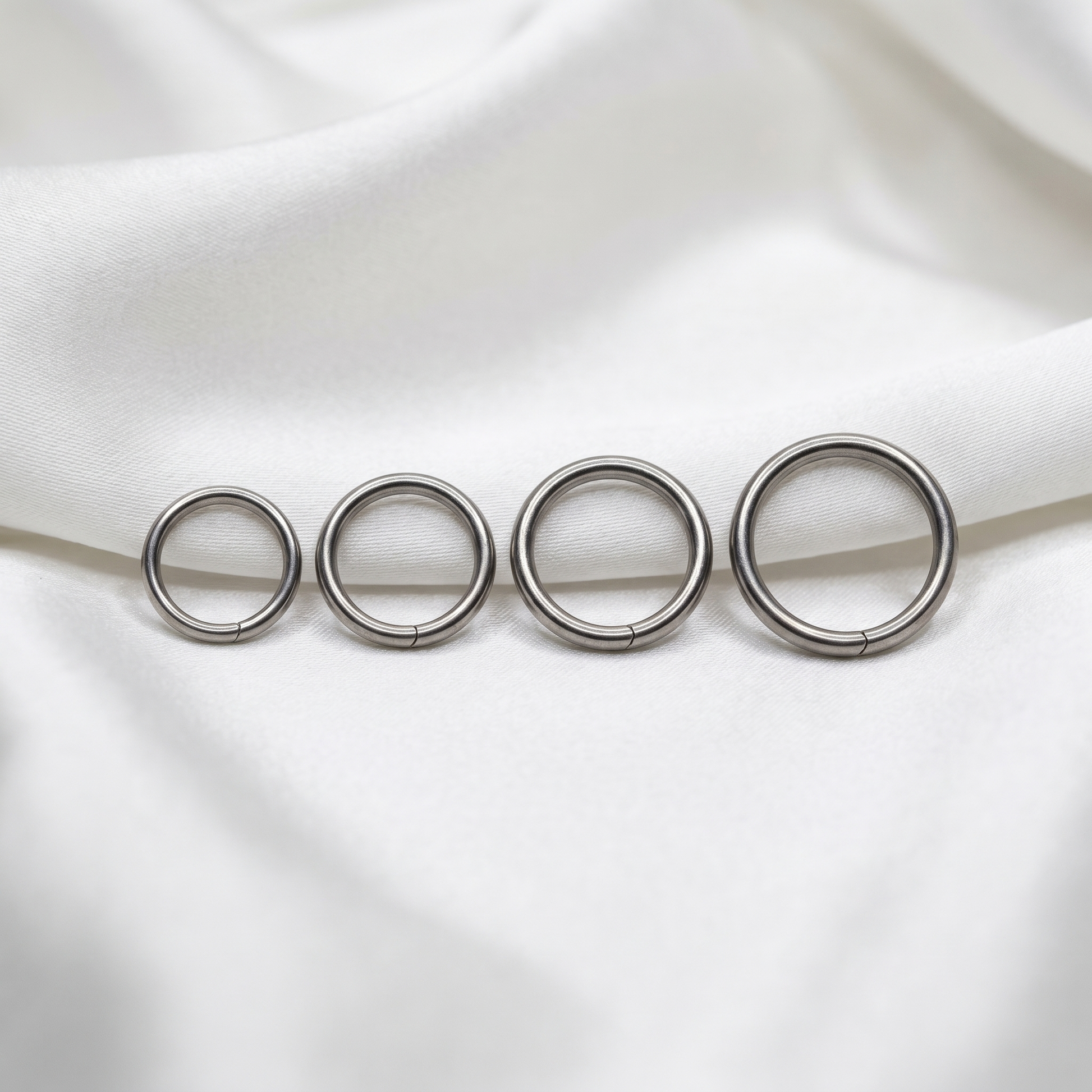 seamless nose hoop sizes shown together — G23 titanium 20G