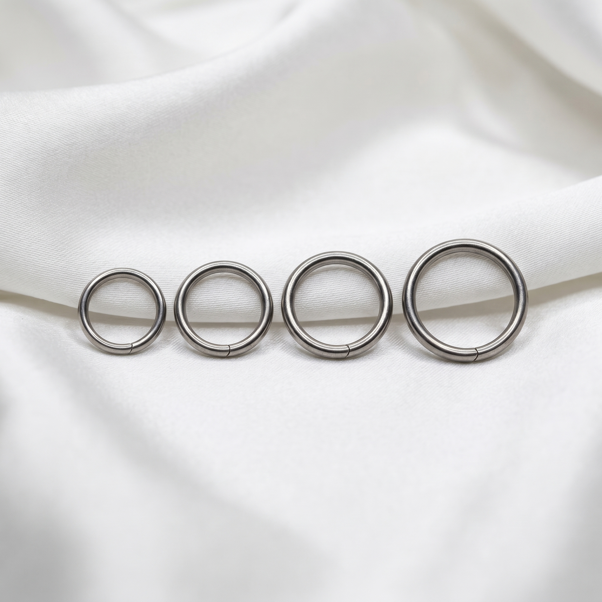seamless nose hoop sizes shown together — G23 titanium 20G