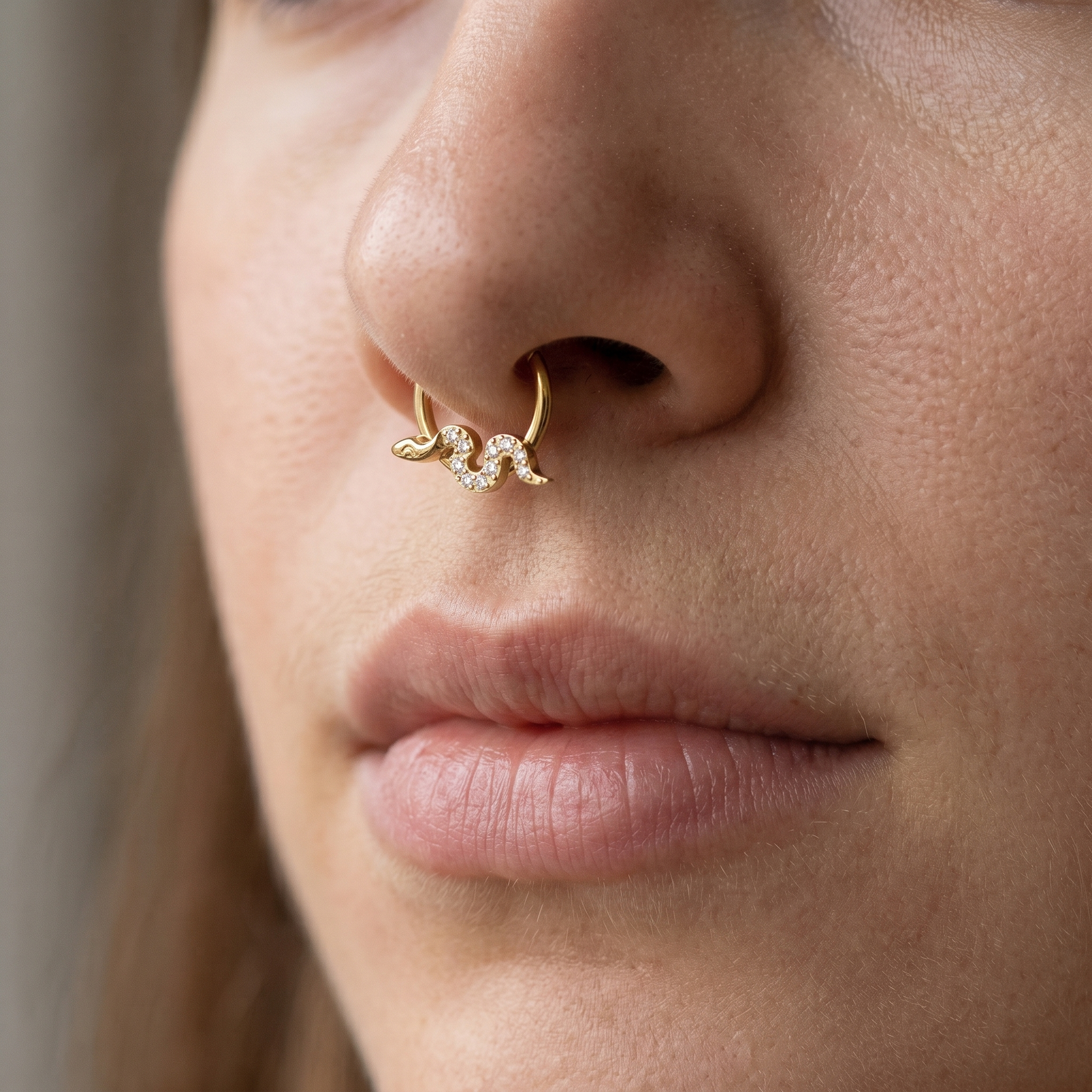 Gold snake zircon daith stud — septum nose placement
