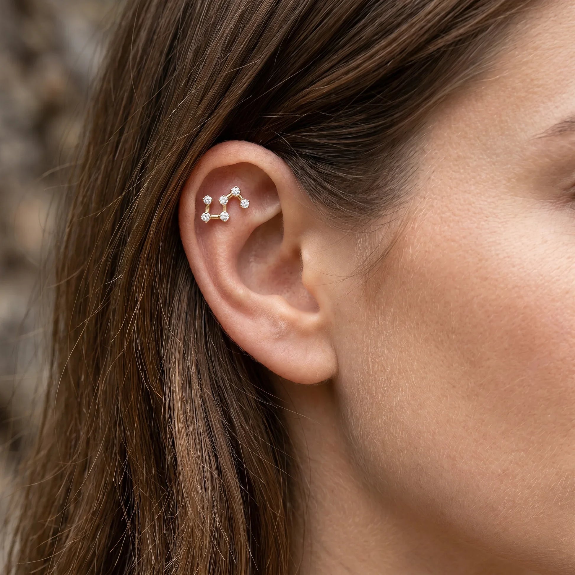 Gold star cluster zircon piercing jewelry styled securely in the upper cartilage