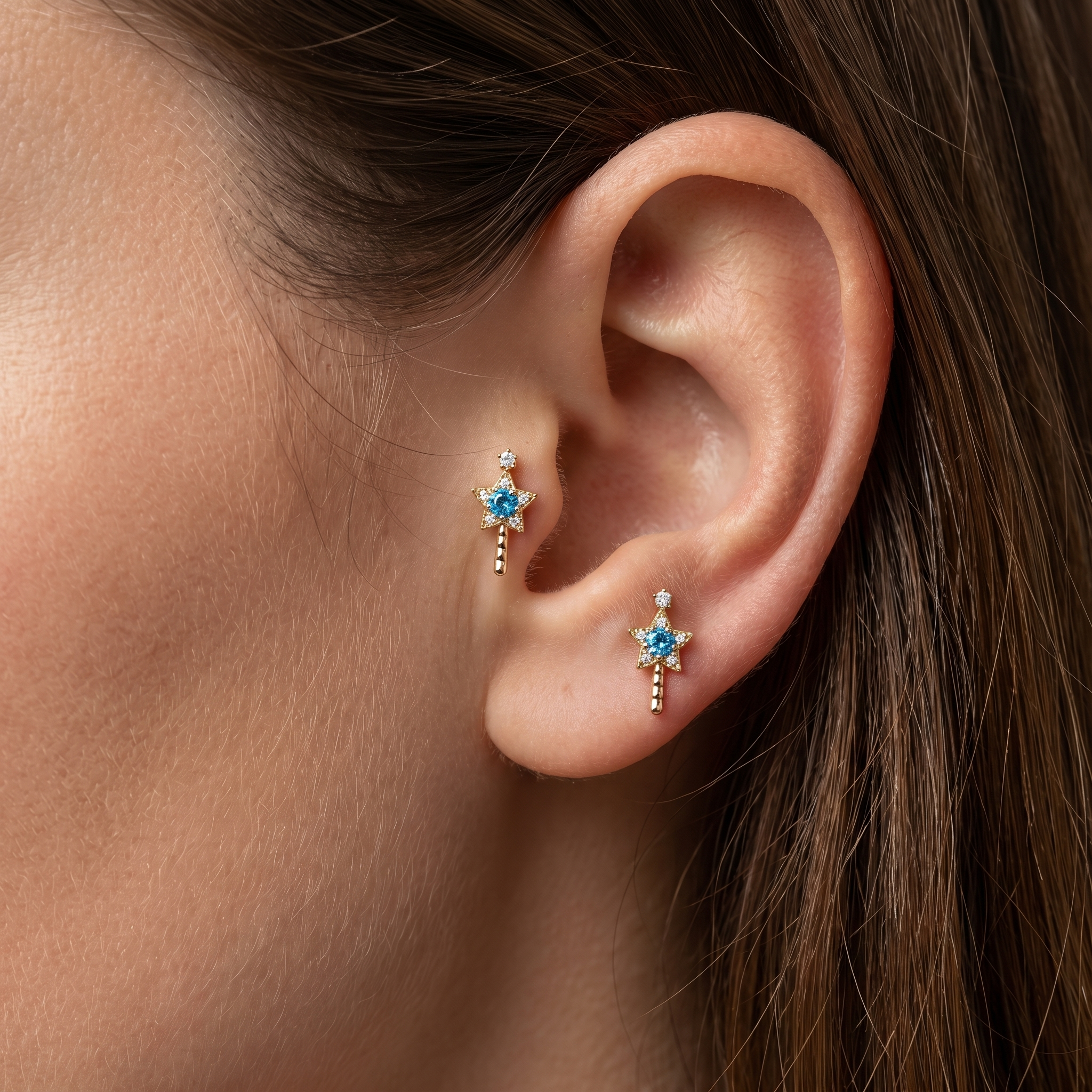 Gold star wand studs styled beautifully in tragus antitragus simultaneously.