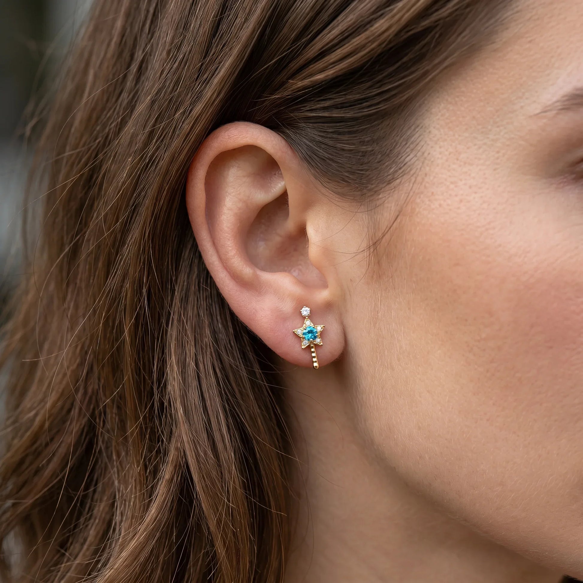 Gold star wand zircon jewelry styled cleanly in a model's standard anti