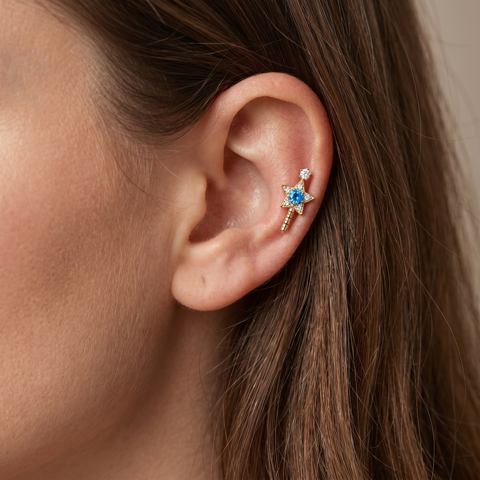 Gold star wand worn comfortably in a cartilage setup.