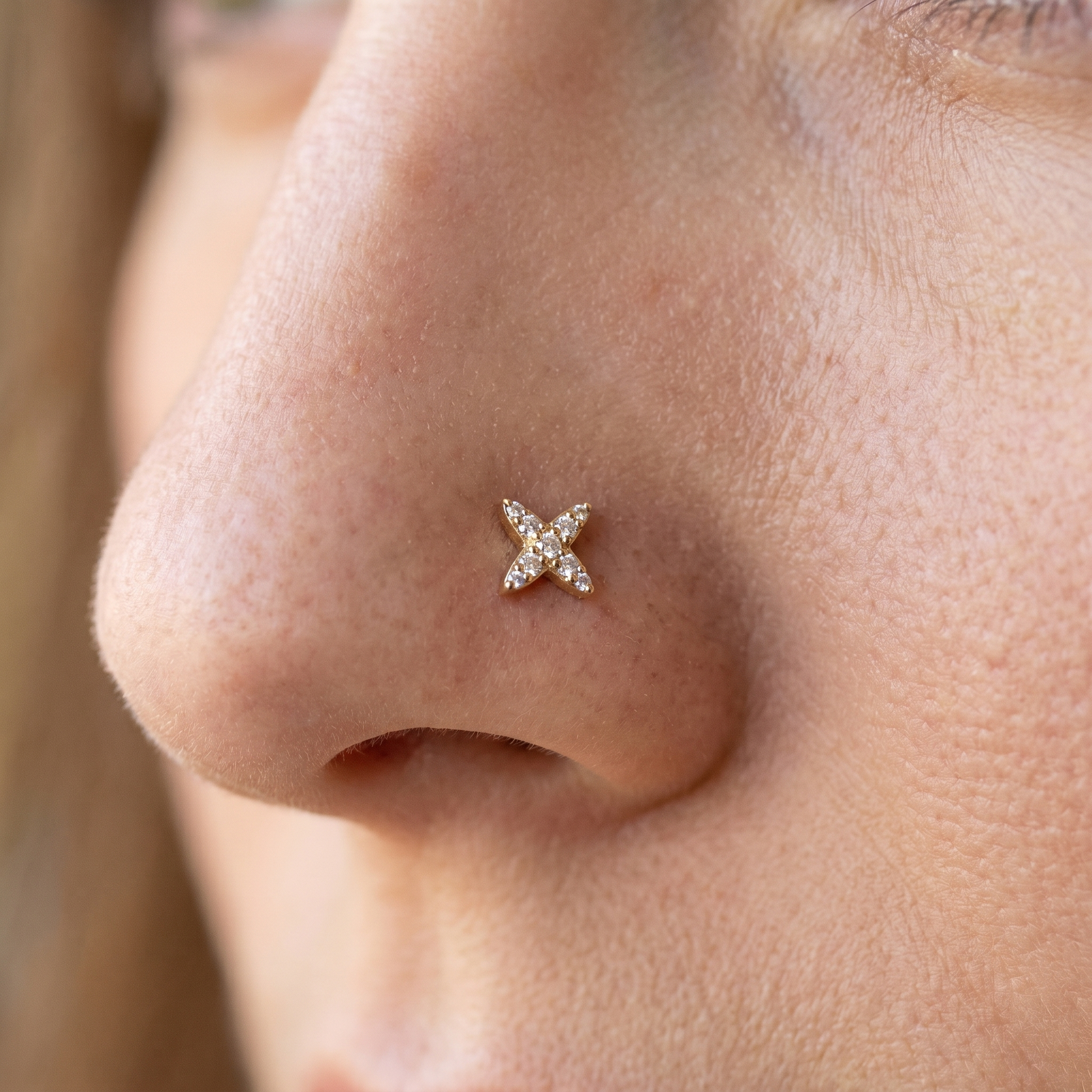 starburst nose stud close-up on a model — single nostril nose jewelry