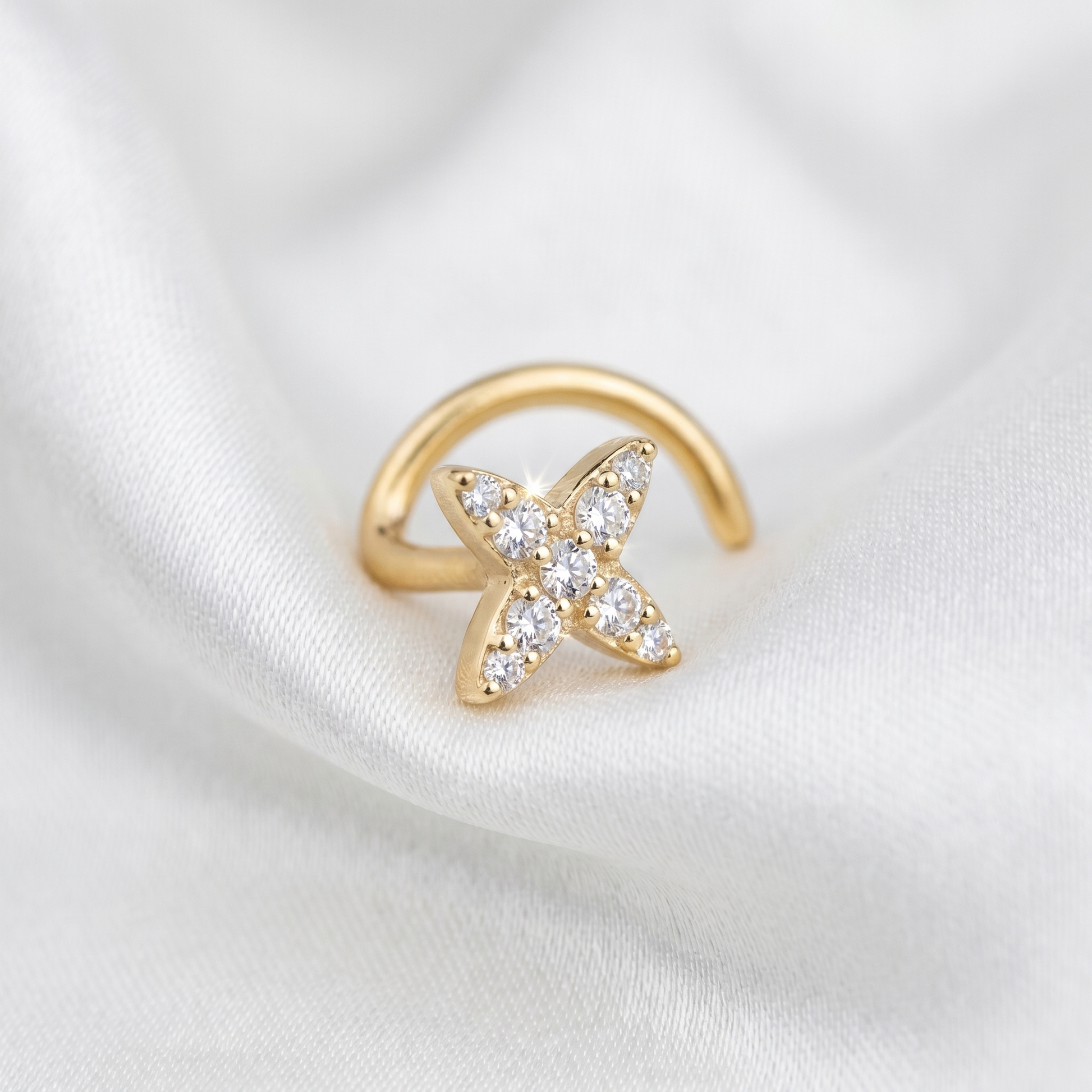 starburst nose stud on satin fabric — G23 titanium 20G