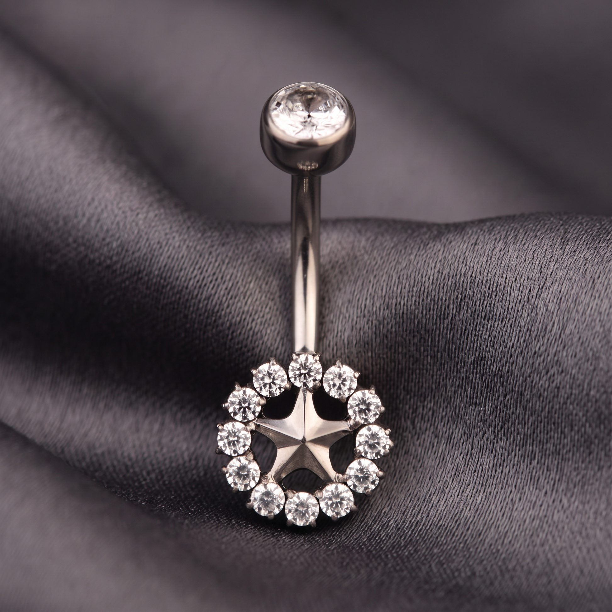 Sunburst belly button ring in silver on champagne satin — G23 titanium 14G