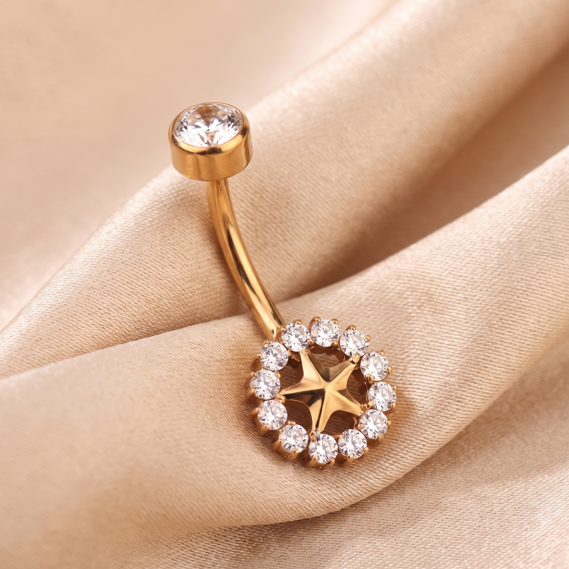 Sunburst belly button ring in gold on champagne satin — G23 titanium 14G