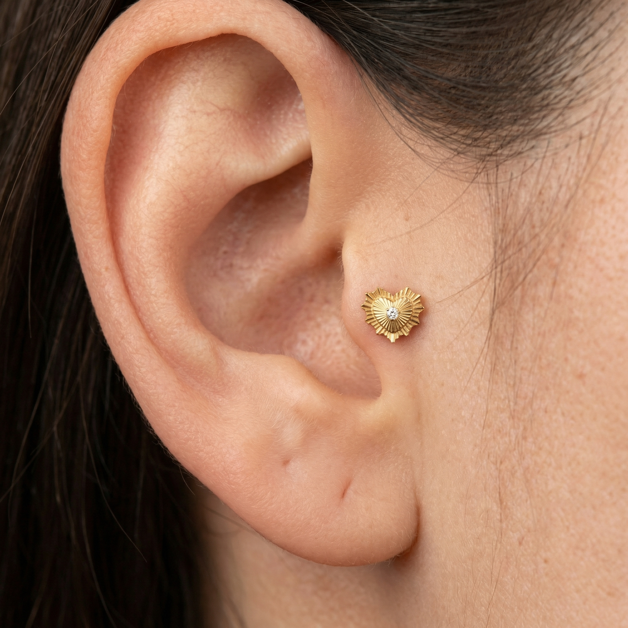 Sunburst Front Helix Piercing - Close-up profile of a