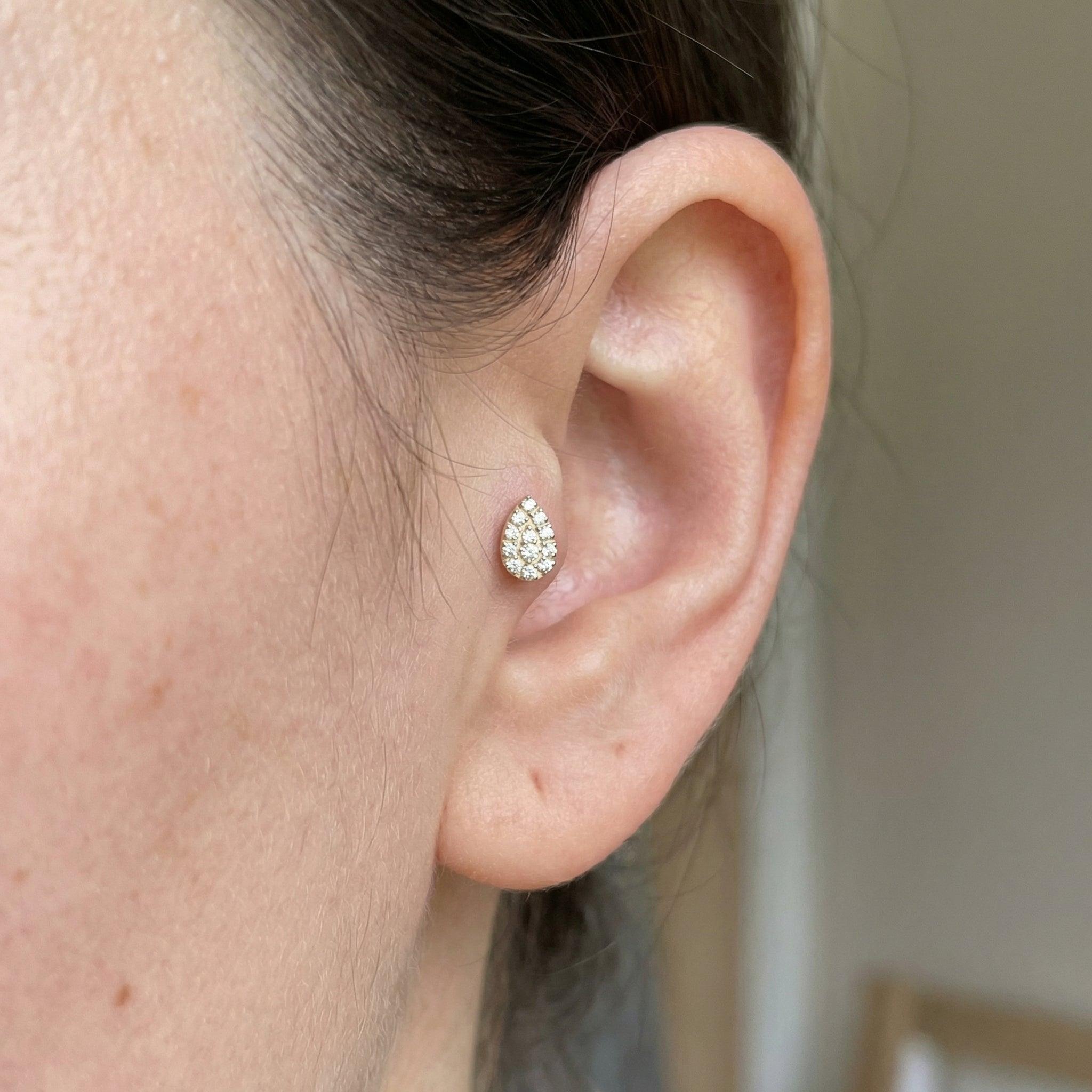 Close-up front profile of a model showing a gold teardrop styled neatly