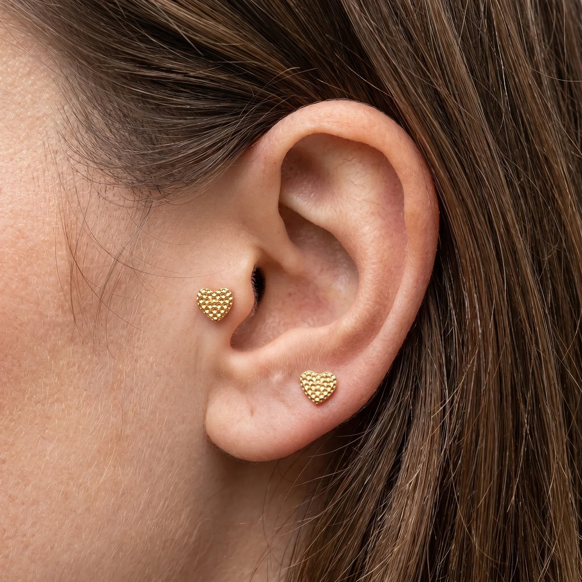 Gold titanium worn in and piercings.