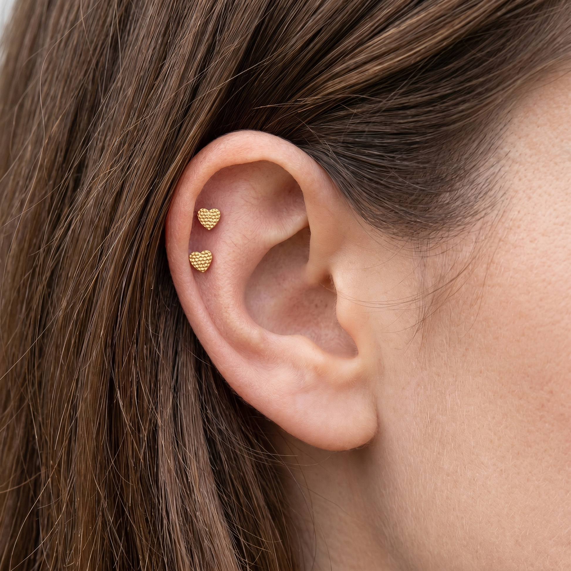 Gold textured heart stud — double helix piercing placement