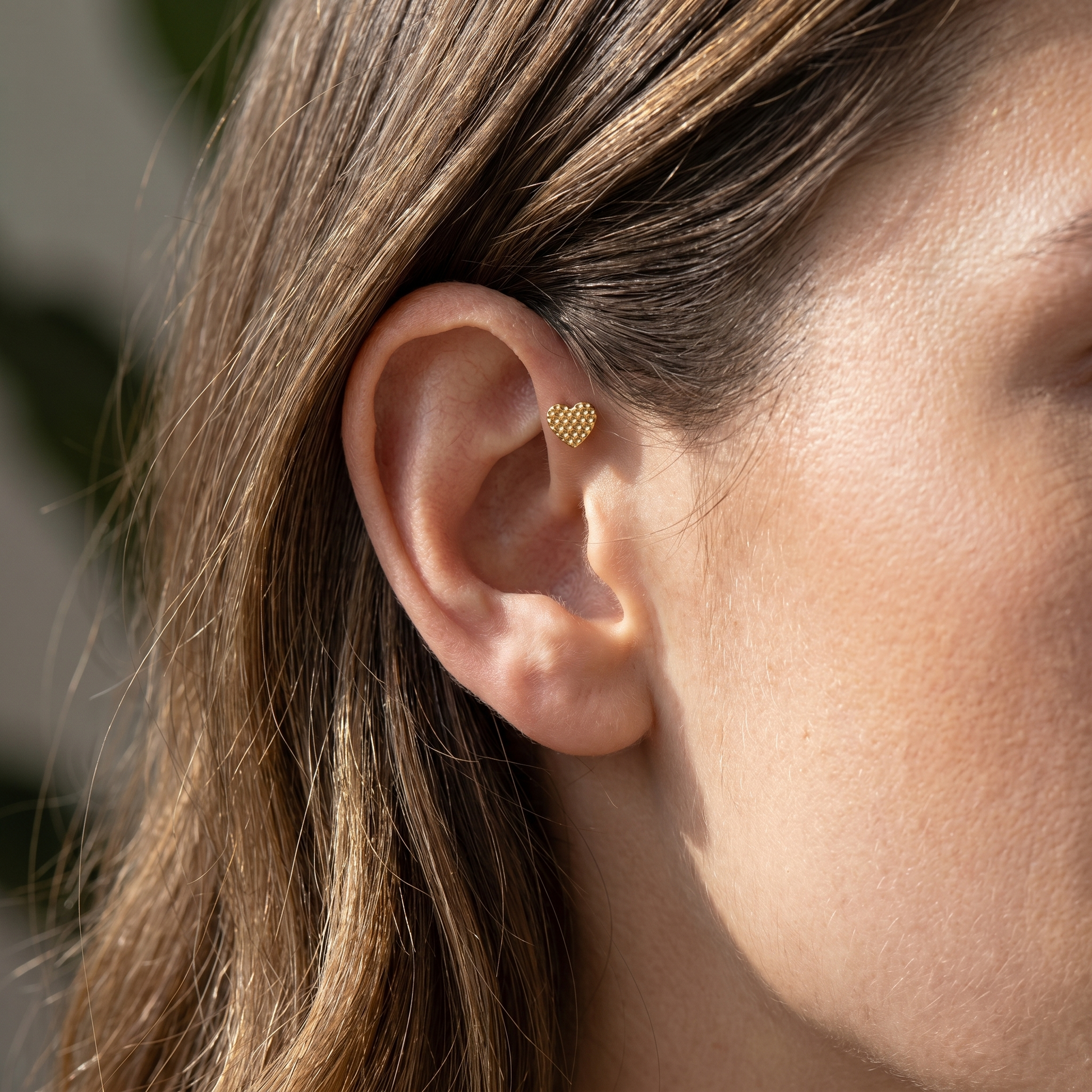 Gold textured heart stud — forward helix piercing placement