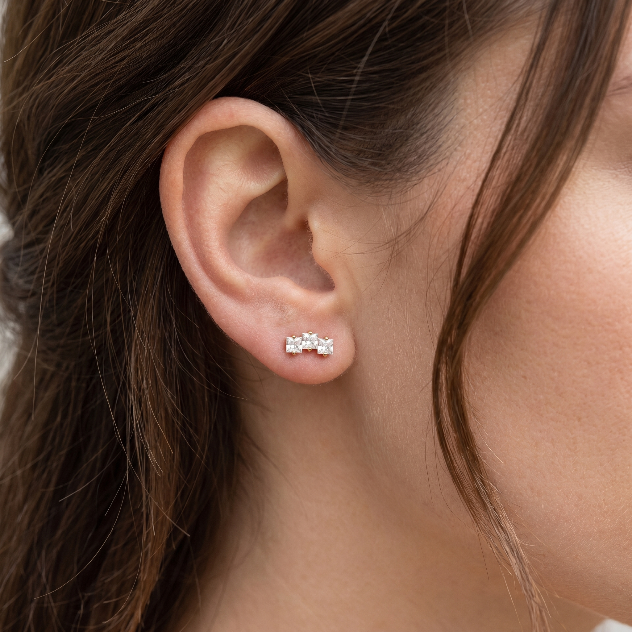 Gold titanium earring worn gracefully in a standard .
