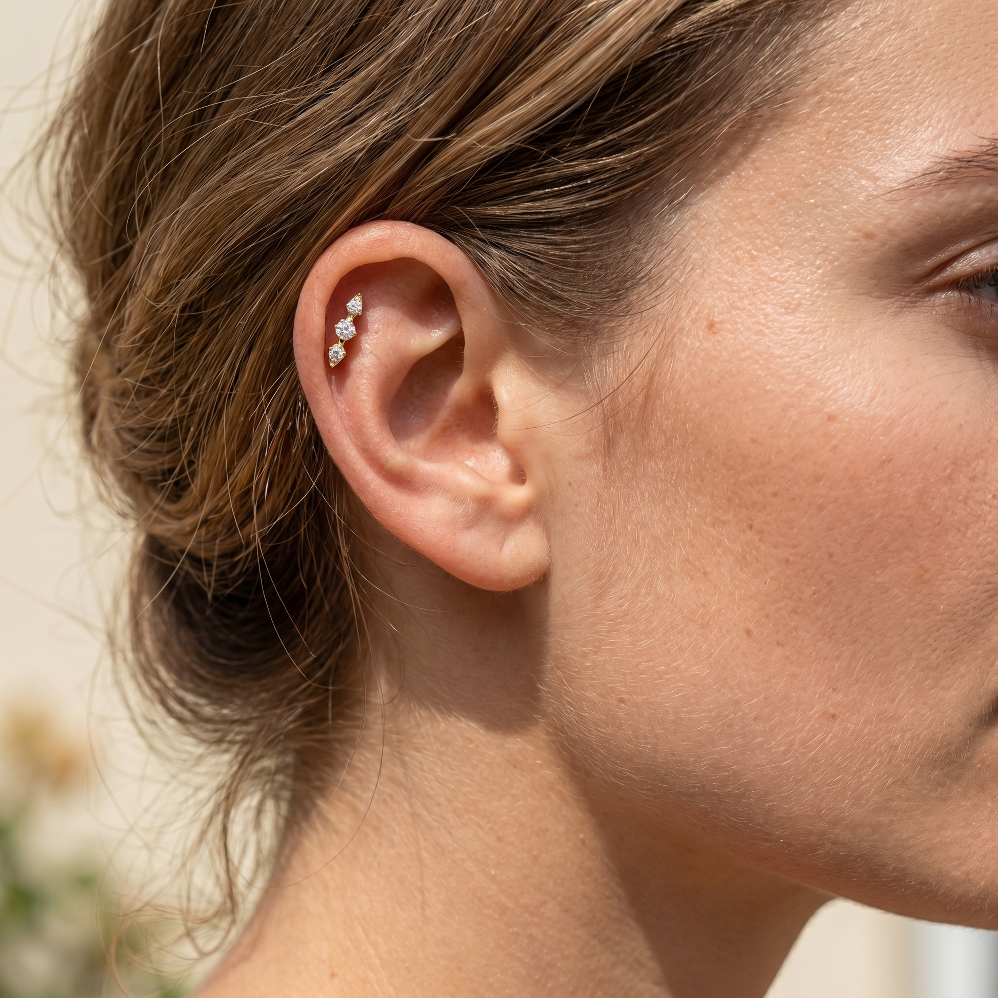 Tragus And Antitragus Piercing - Model showcasing a gold