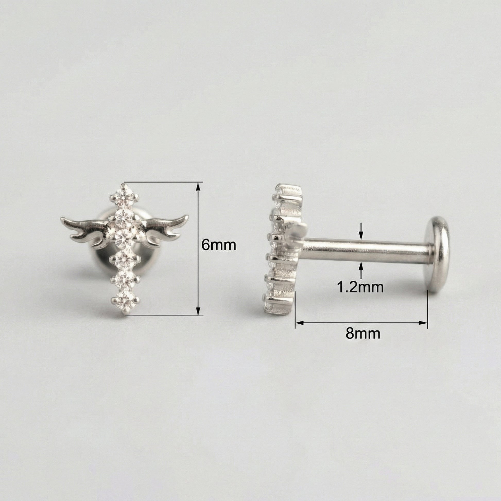 Measurement layout for a silver titanium winged cross showing an 8mm bar