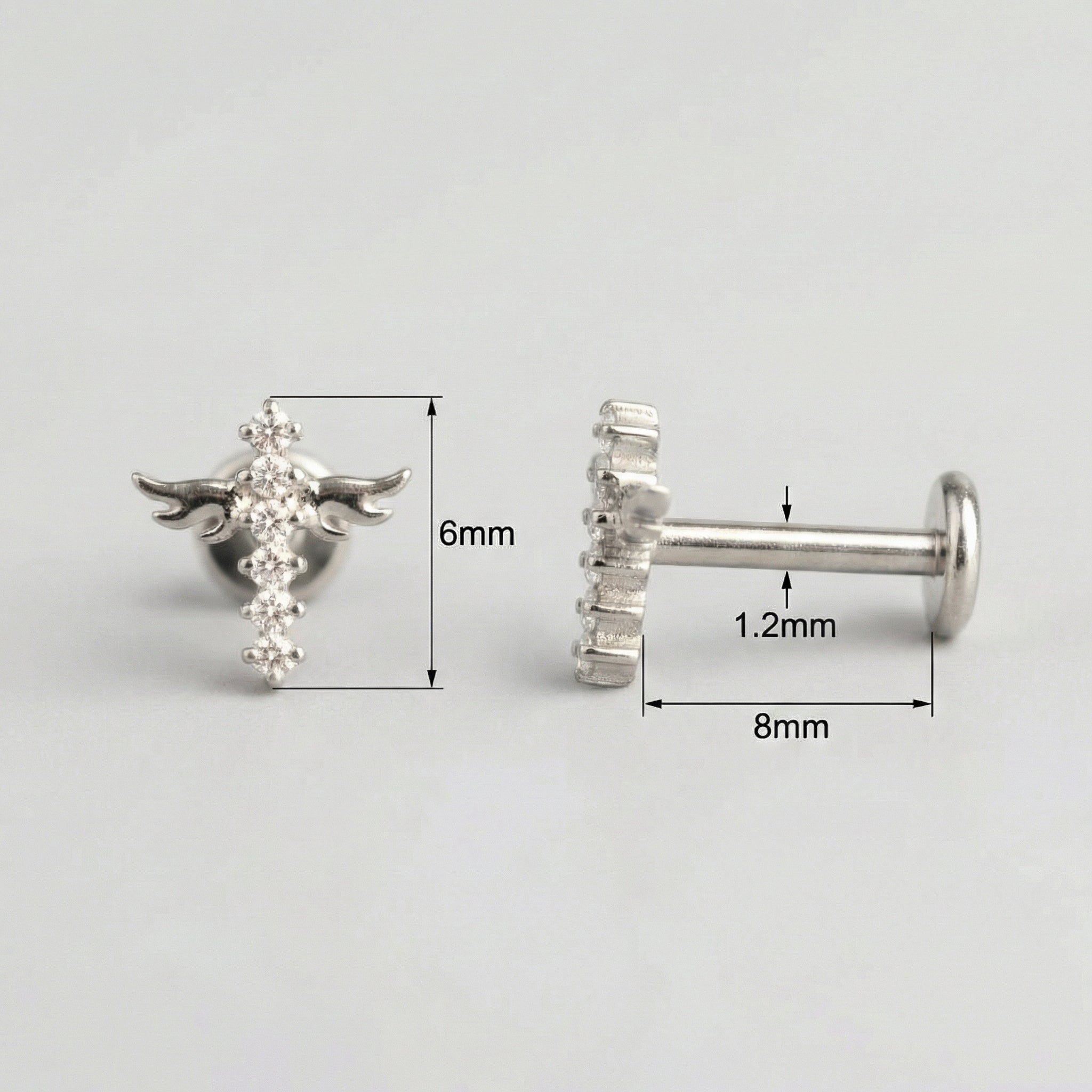Measurement layout for a silver titanium winged cross showing an 8mm bar