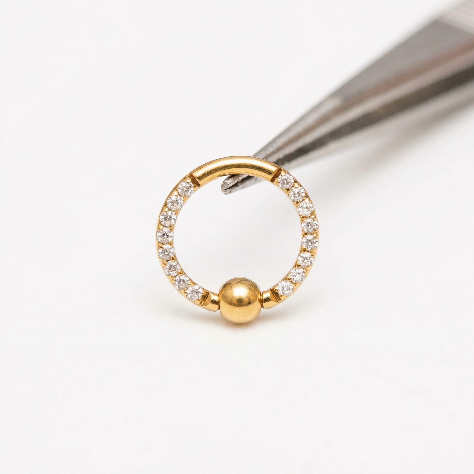 Earrings For A Daith Piercing - Precision tweezers holding a