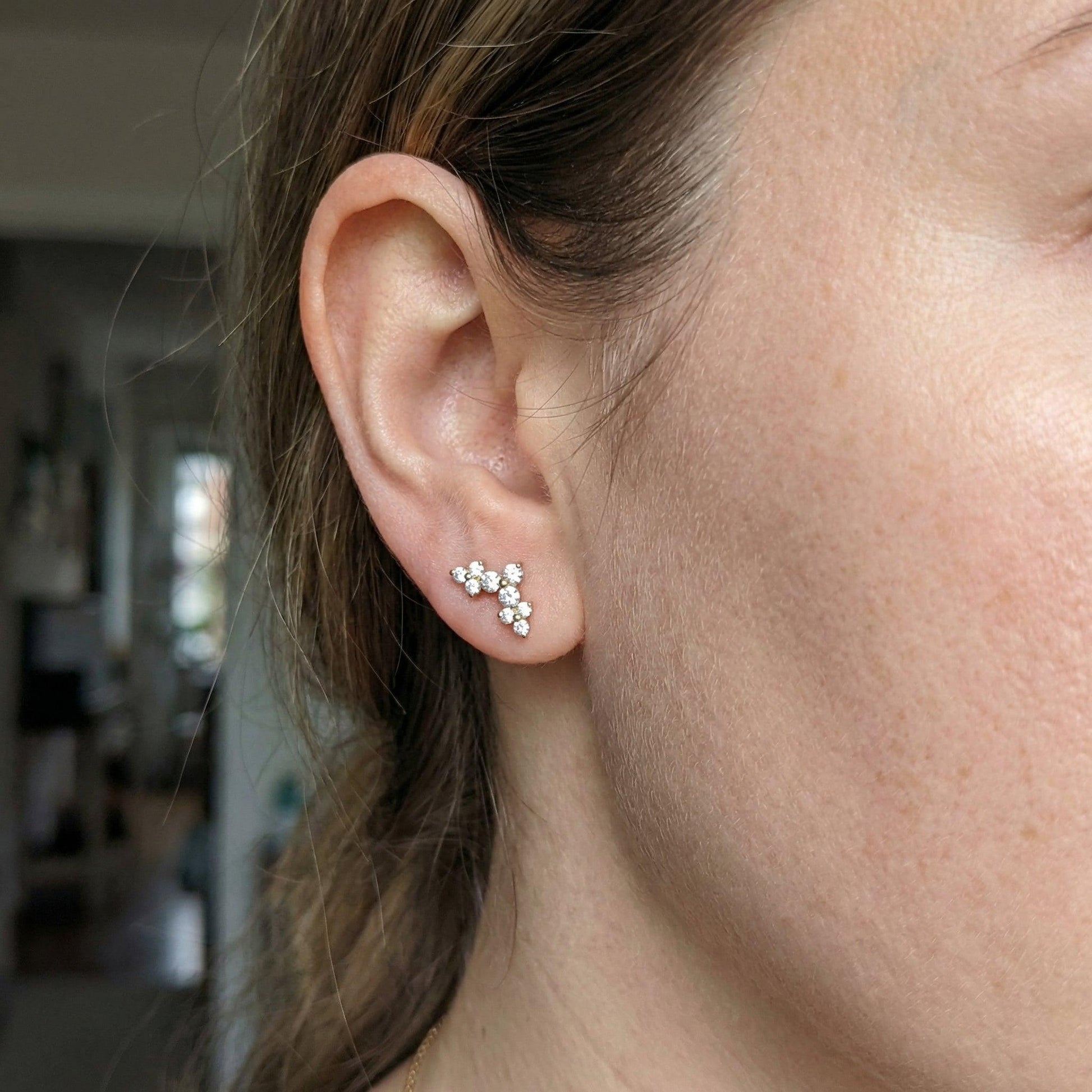 Model showcasing a silver elegant cluster in her upper piercing.