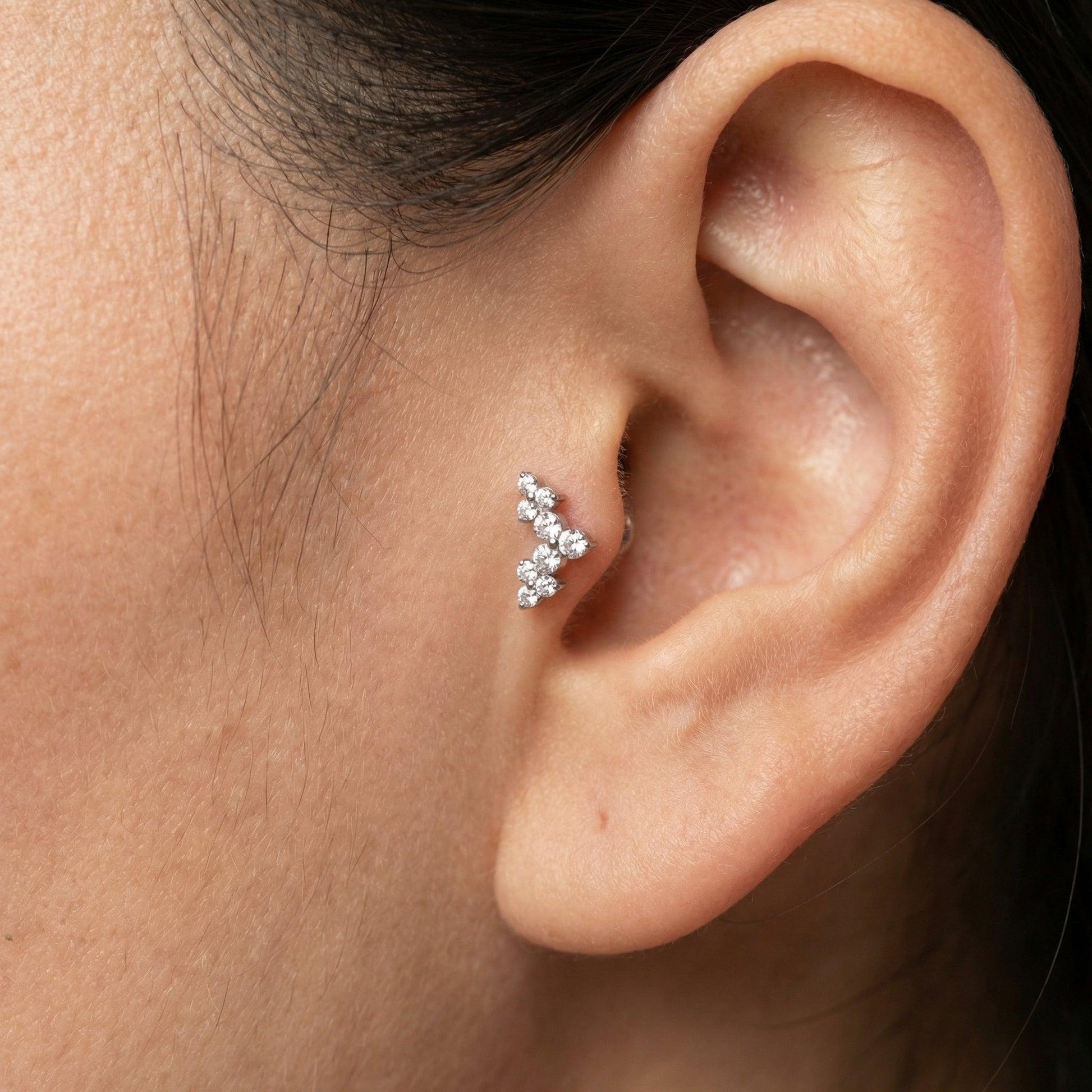 Model showcasing a silver elegant cluster zircon perfectly placed in an inner