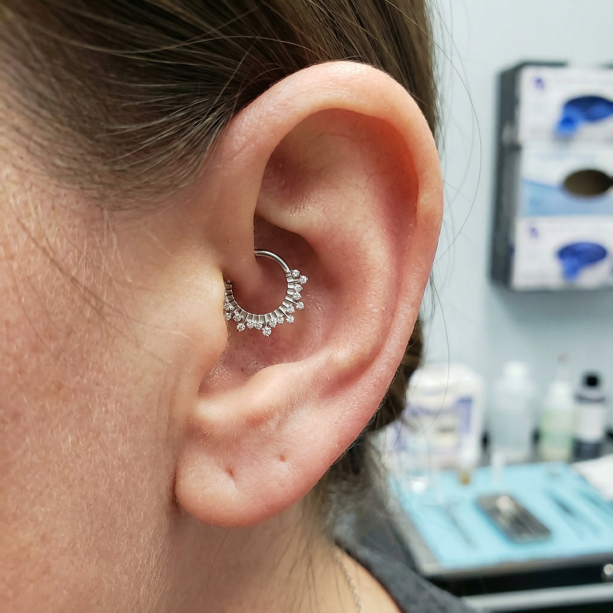 Model wearing a silver titanium zircon crown clicker elegantly placed in her